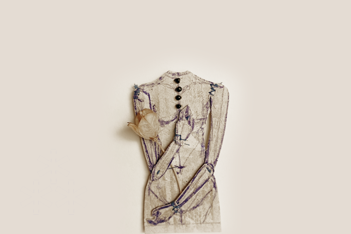 An embroidered carton with a sketch of a woman's torso and arms, adorned with black buttons down the front and a dried flower pin on the chest, set against a plain beige background.
