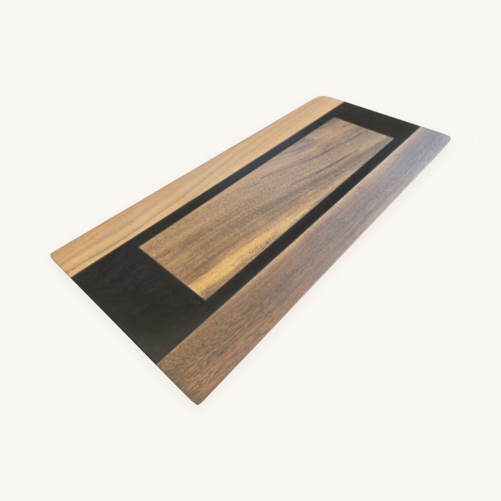 Walnut epoxy serving tray with a black epoxy frame and walnut center panel, angled view