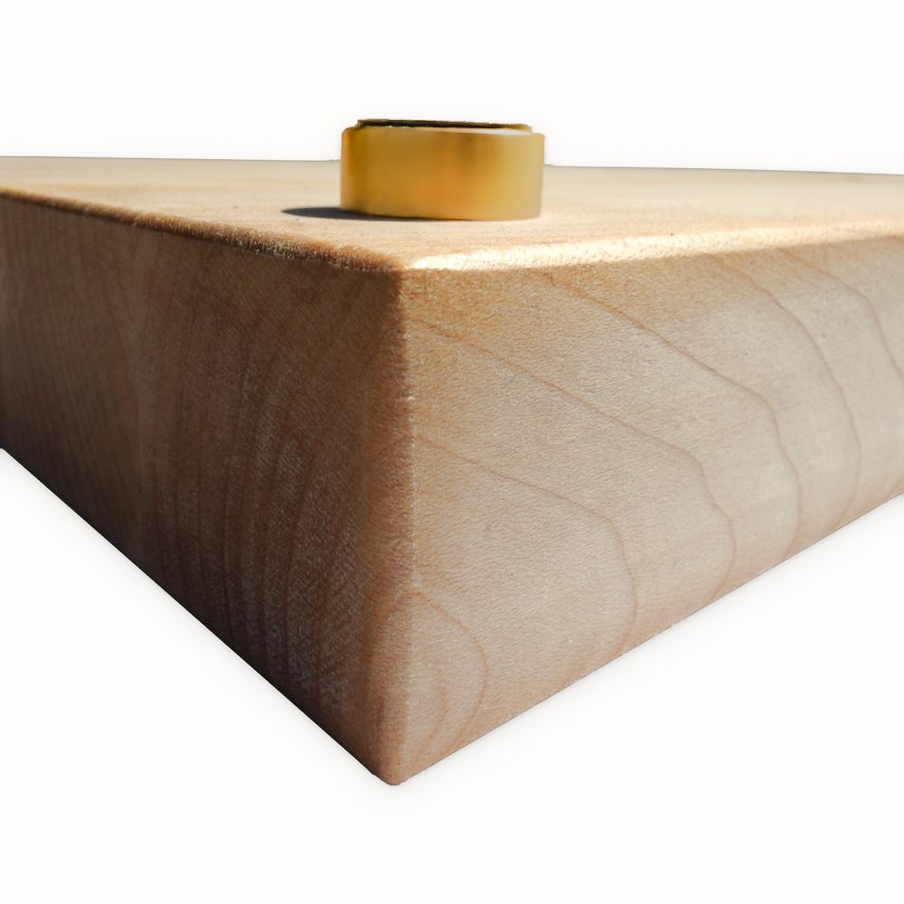 Elevated butcher block corner on a brass disc riser