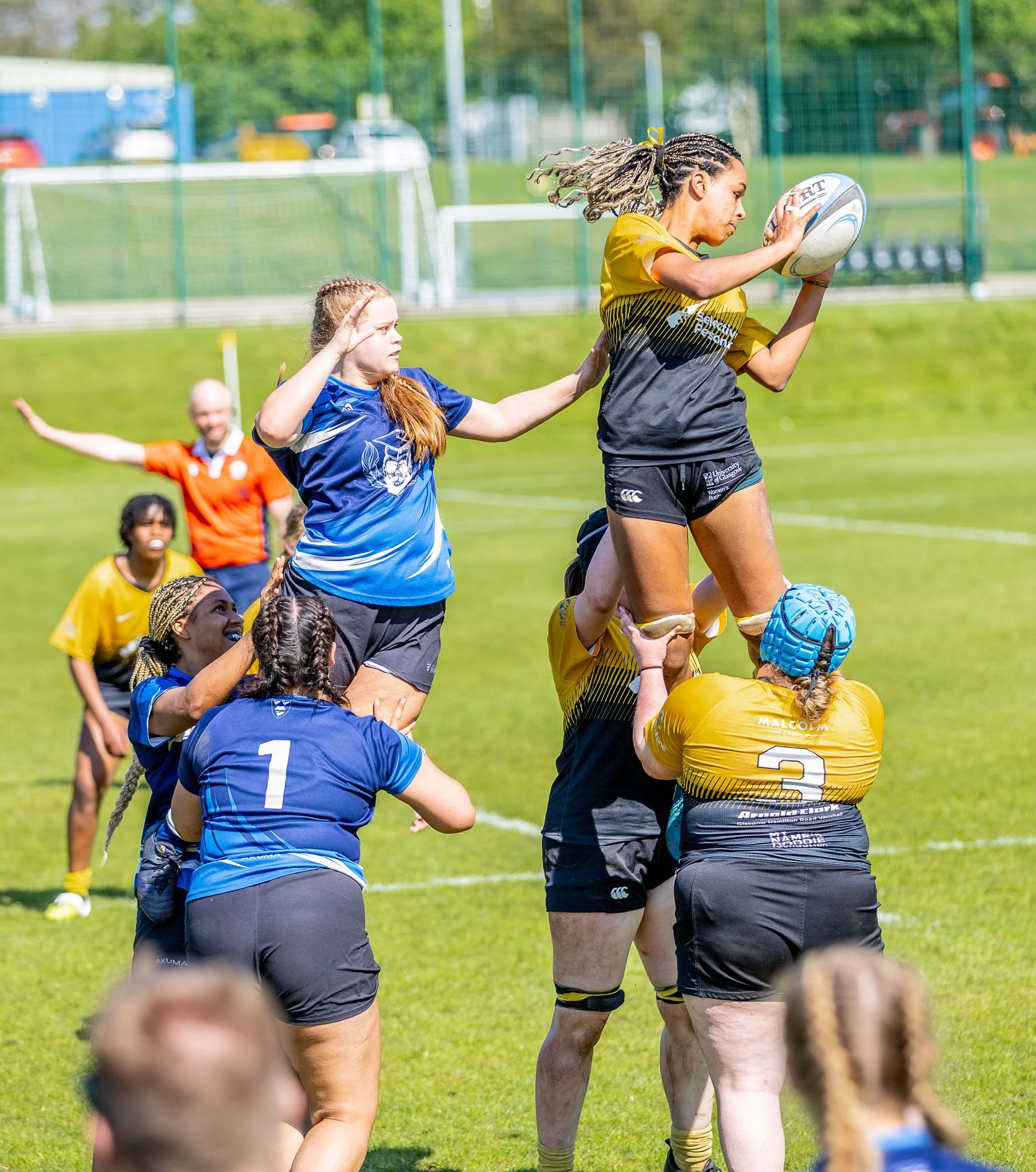 Female rugby player catching the ball at a line out