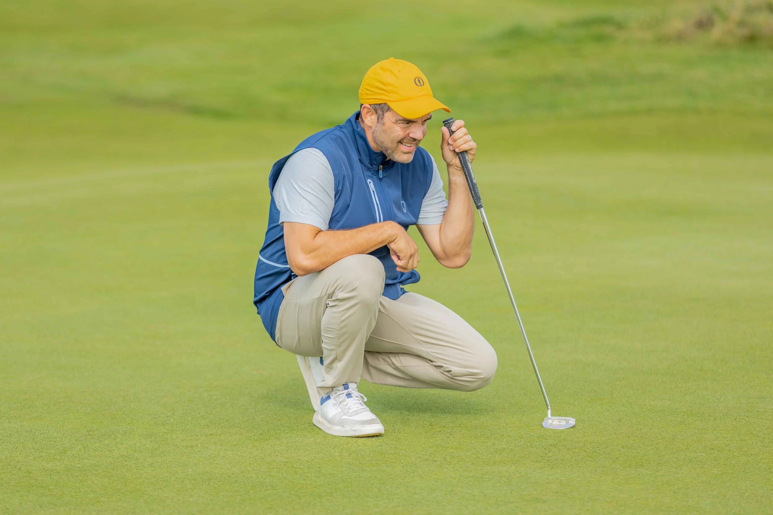 Picture of a golf group player lining up a put