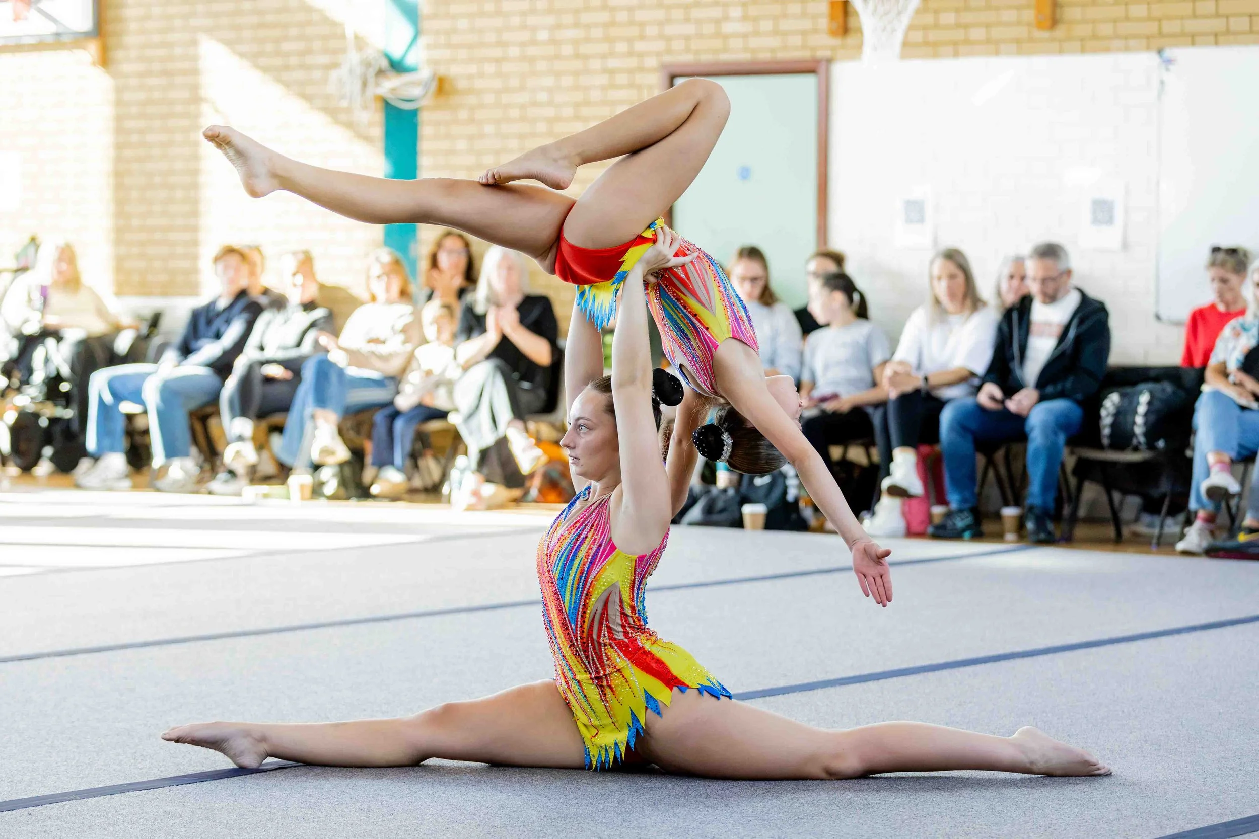 Acro gymnast pair performing at the Falcon Invitational competition