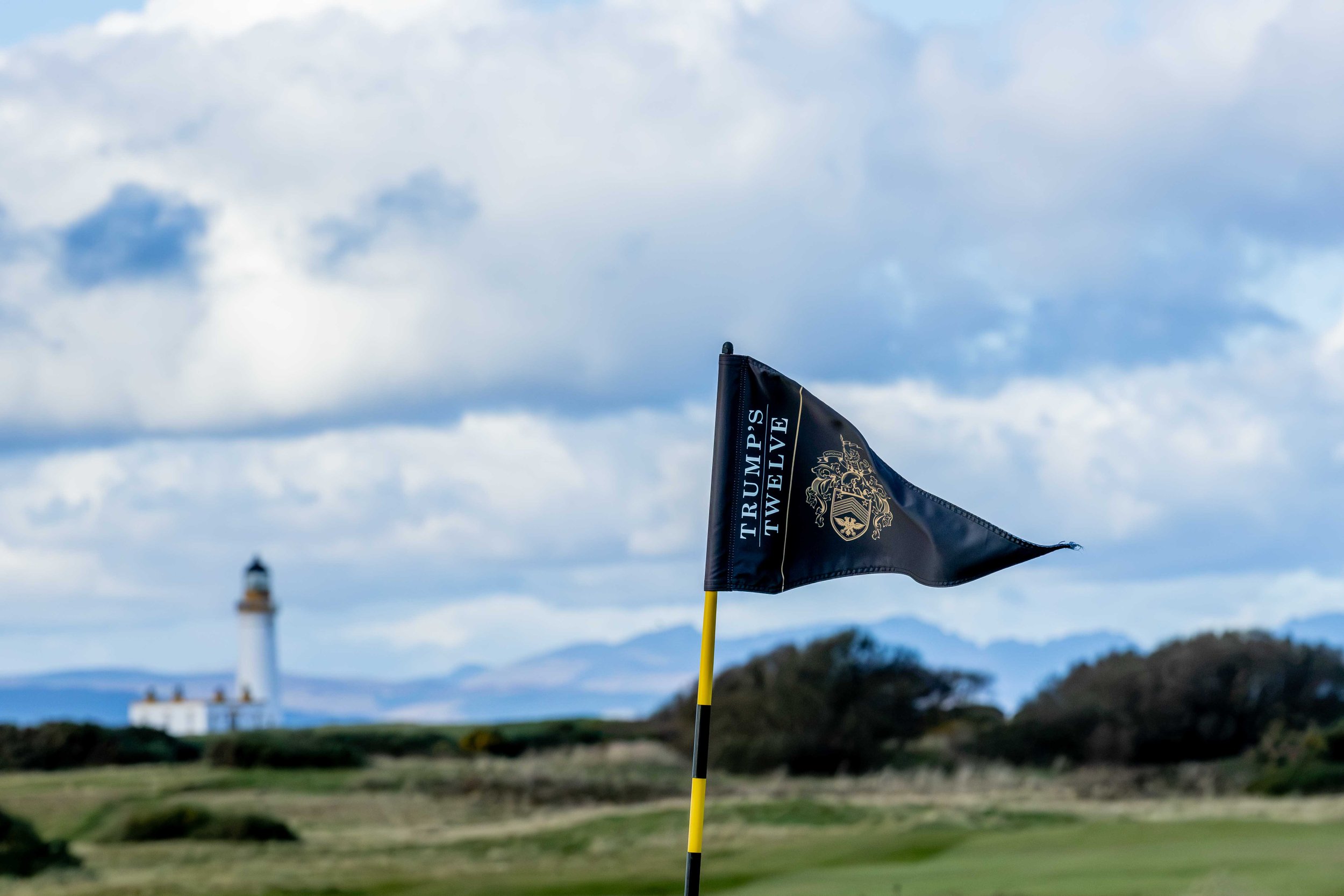 Trump Twelve flag with Turnberry lighthouse in the background
