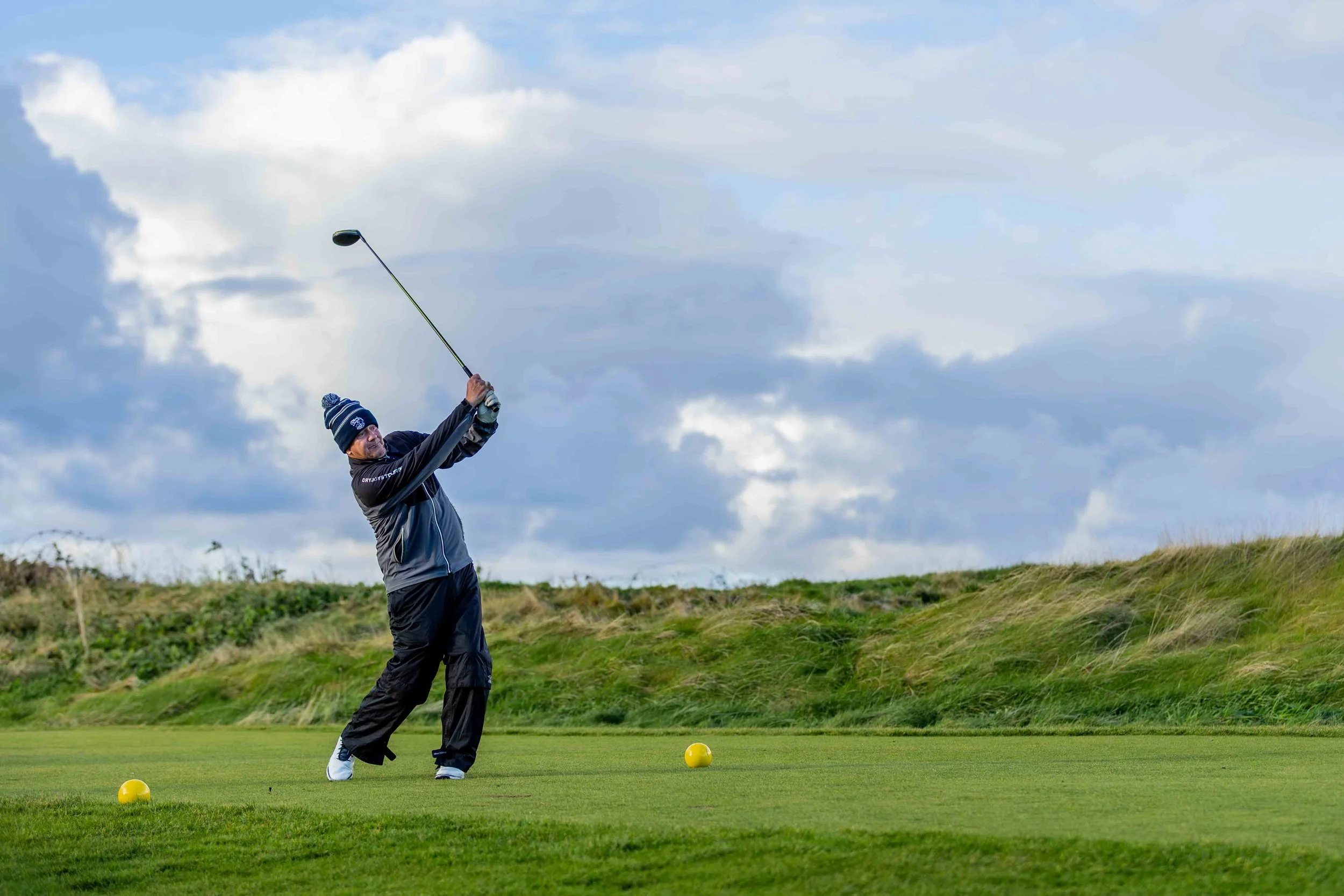 Golfer teeing off at the 2026 Turnberry Titans charity event