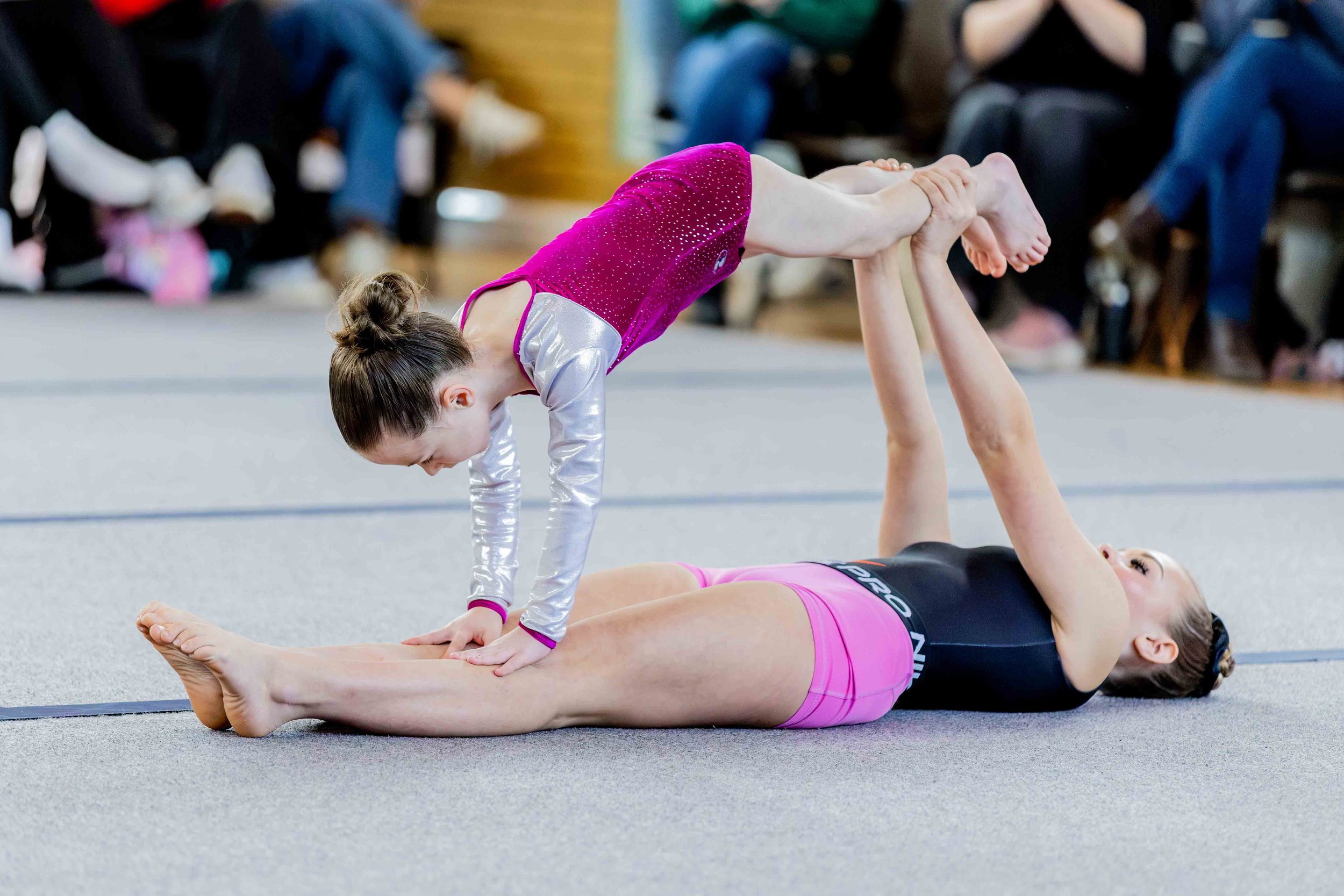 Gymnast with a disability performing a balance with her partner