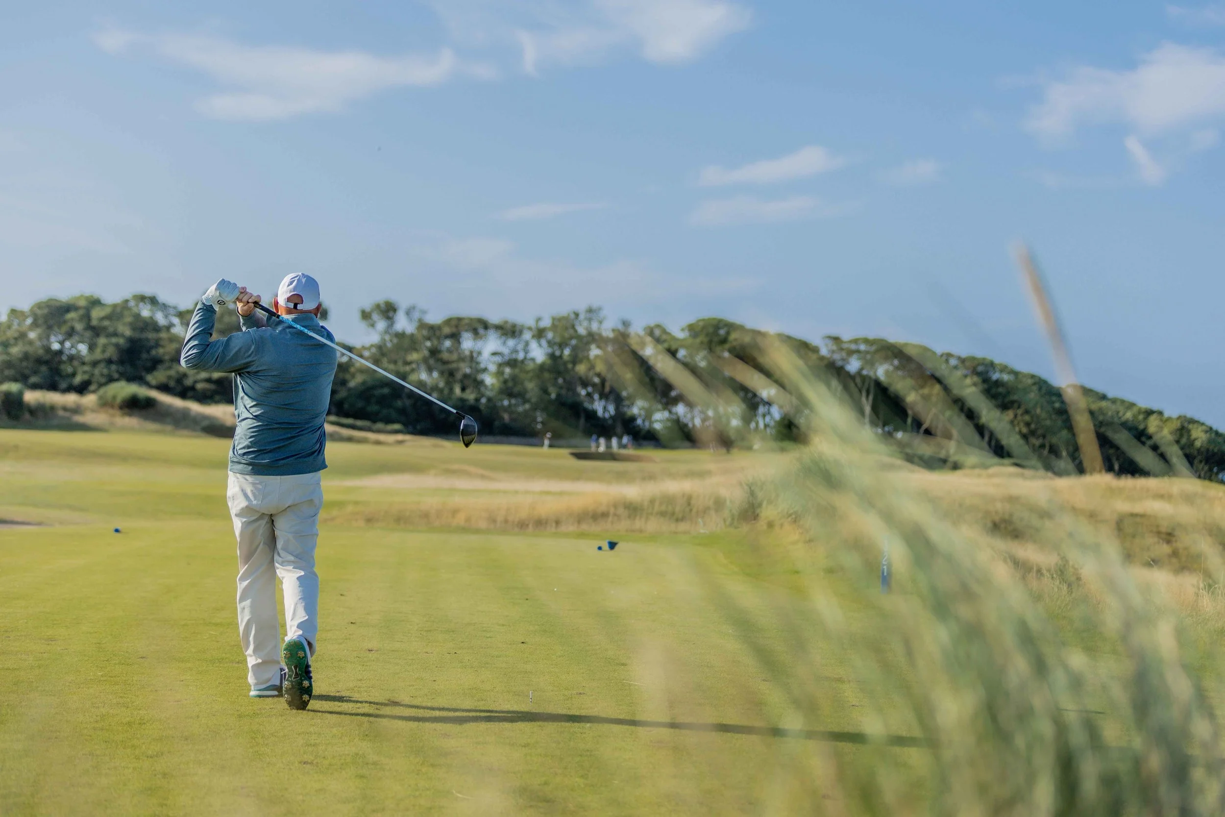 Golf pro driving at Kingsbarns Golf Links