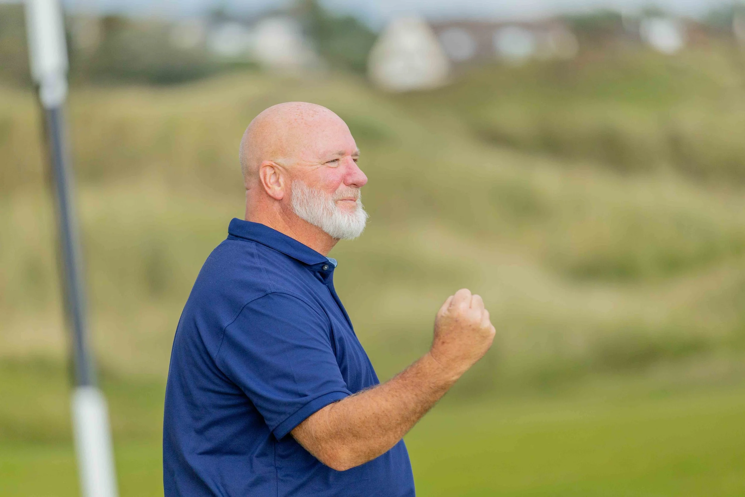 Golfer celebrating after holeing a put