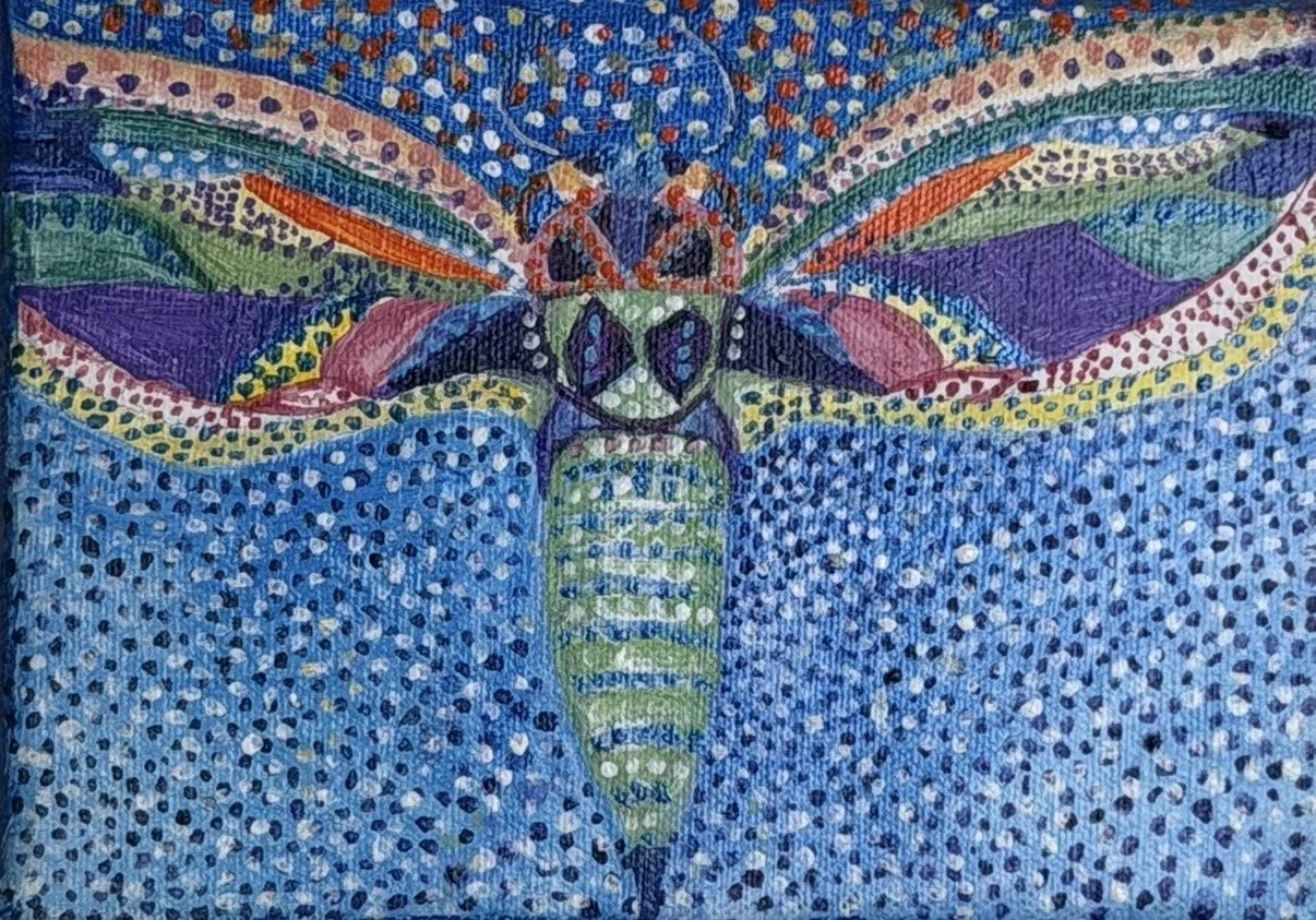 Close-up of a colorful, abstract painting of a butterfly with vibrant patterns and a dotted background.