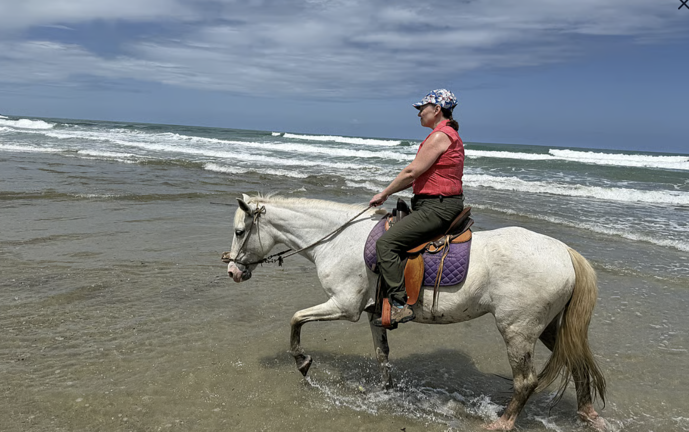 Pure Bliss Retreat guest horseback riding along the Caribbean coast of Costa Rica