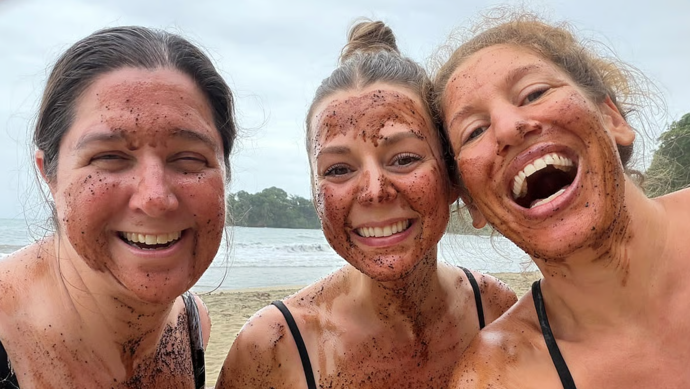 Pure Bliss Retreat guests enjoying a playful cacao spa experience on the beach in Costa Rica