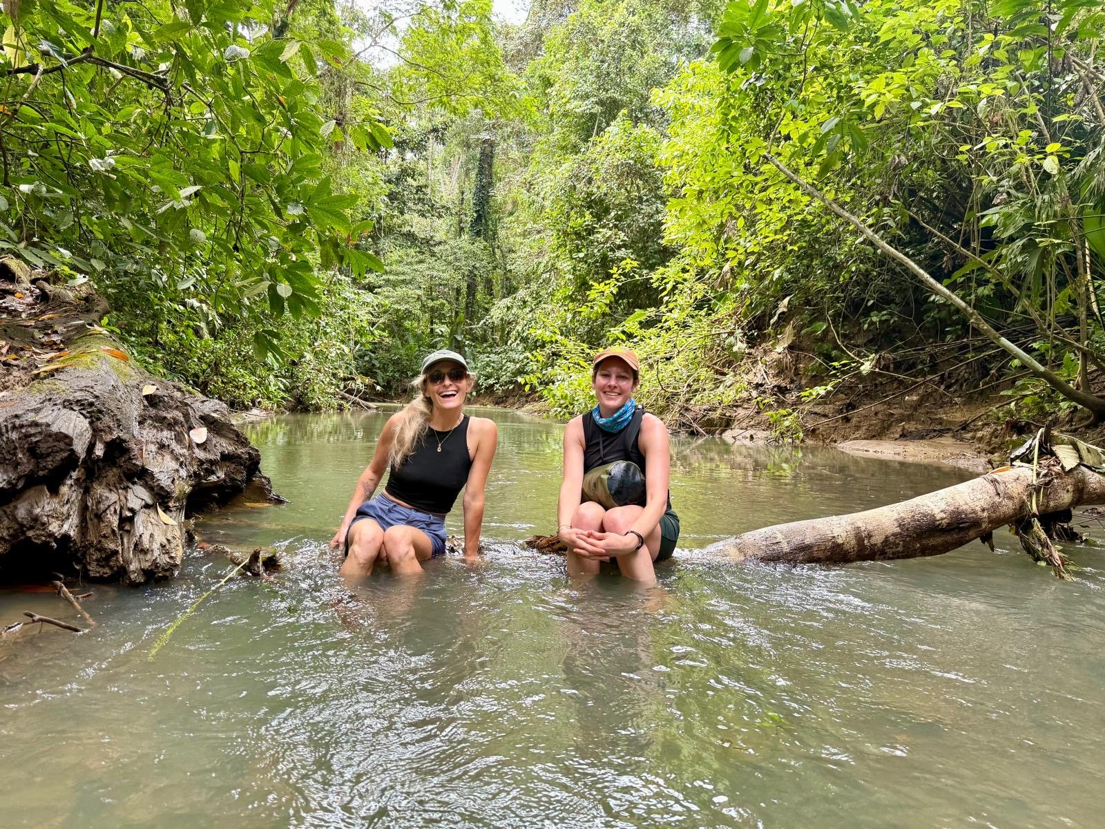 Pure Bliss Retreat guests relaxing together in a jungle river on the Caribbean coast of Costa Rica