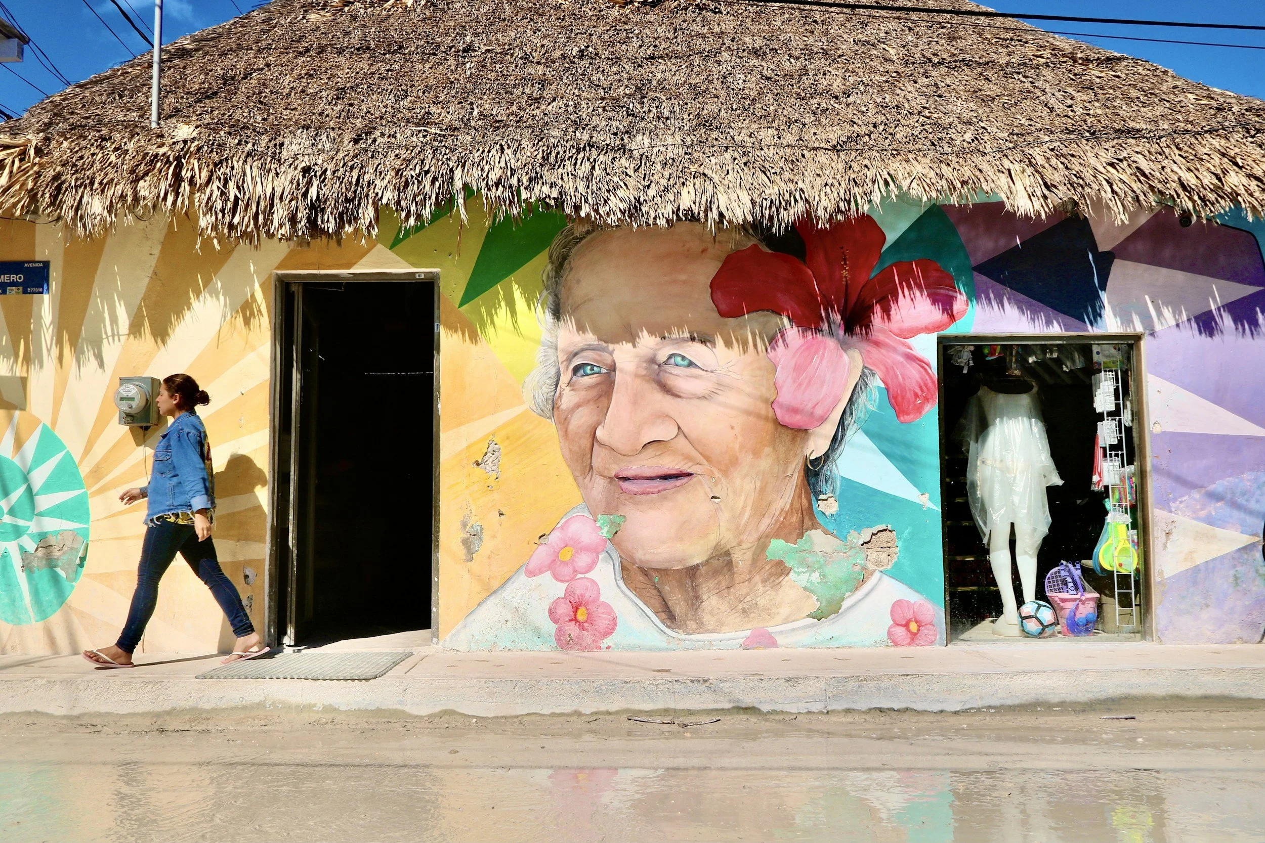 Colorful street mural featuring a woman in a flowered headpiece in Mexico.