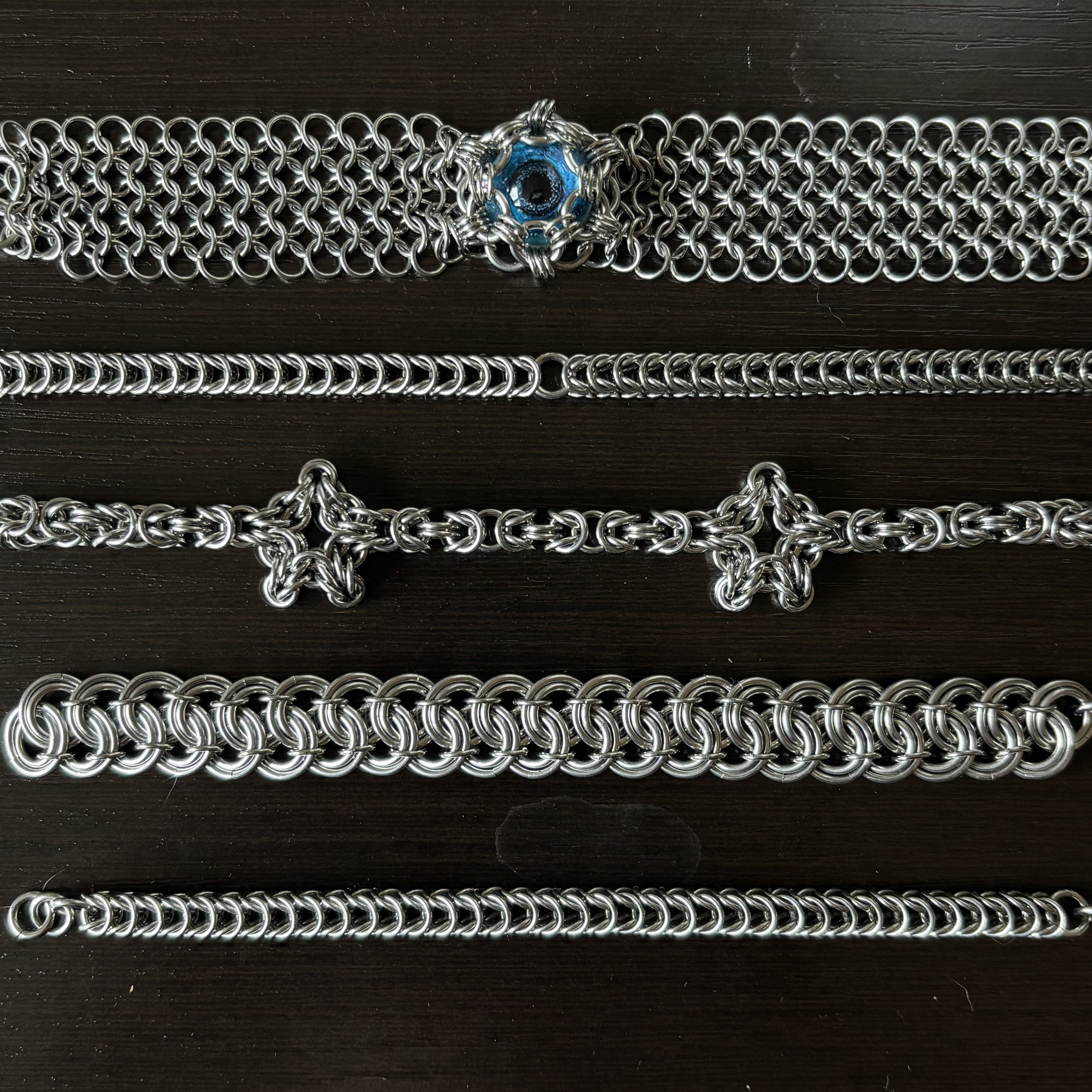Top to bottom: European eyeball bracelet, Box chain, Byzantine with stars, Garter belt, Box chain continuous