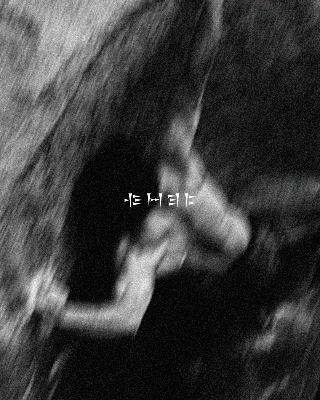 A blurred black and white photo of a climber on the rocks.