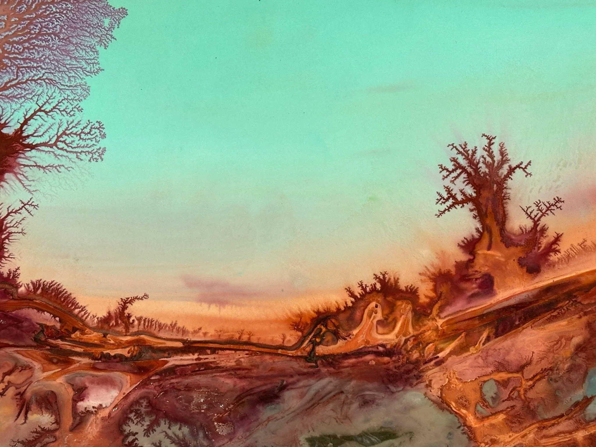 Abstract watercolor painting featuring a gradient sky from green to pink, with bare tree branches stretching across the bottom and left sides of the image.