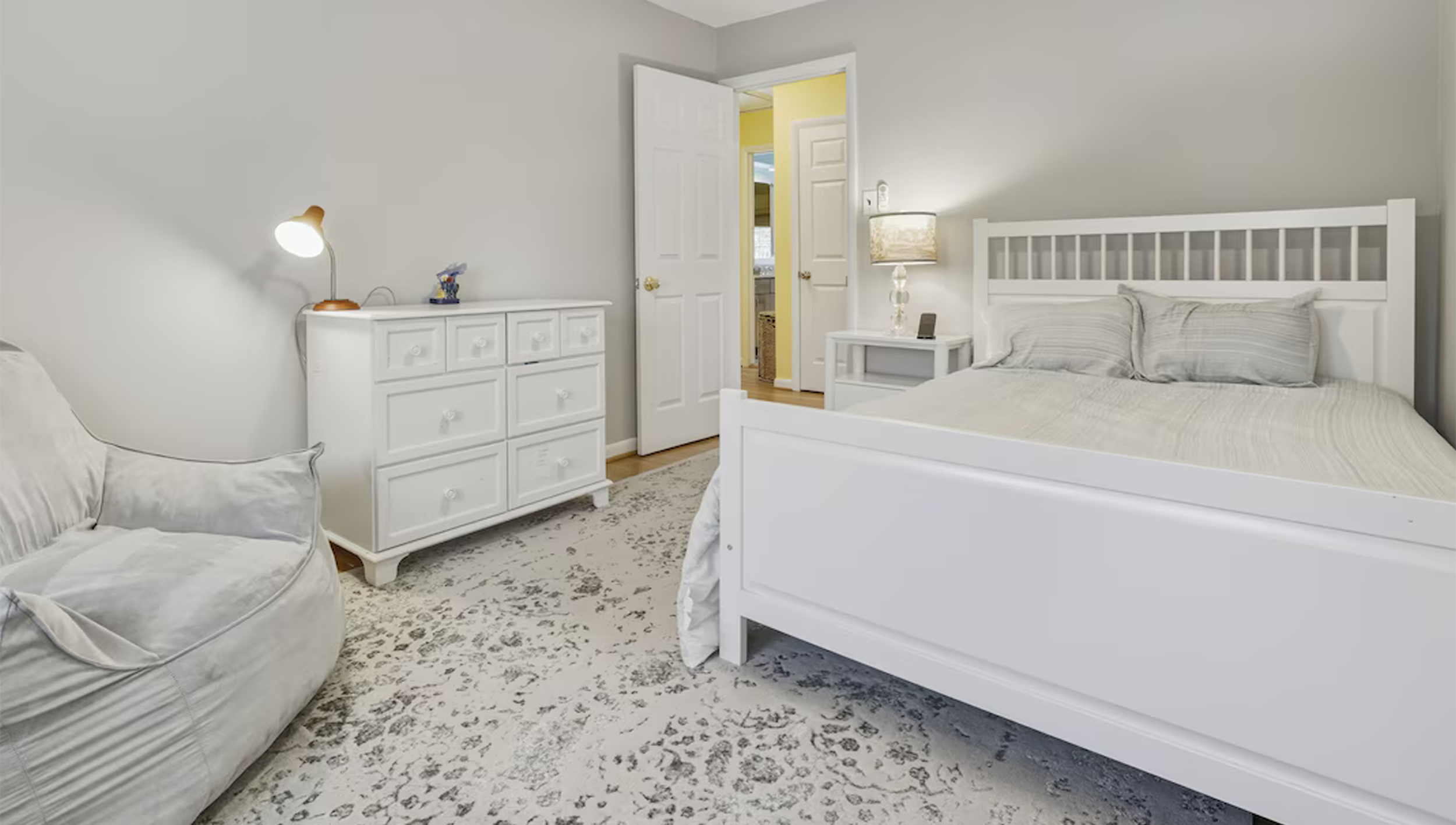 Bright guest bedroom with dresser and comfortable sleeping space at Bayberry Retreat in Arnold, Maryland.