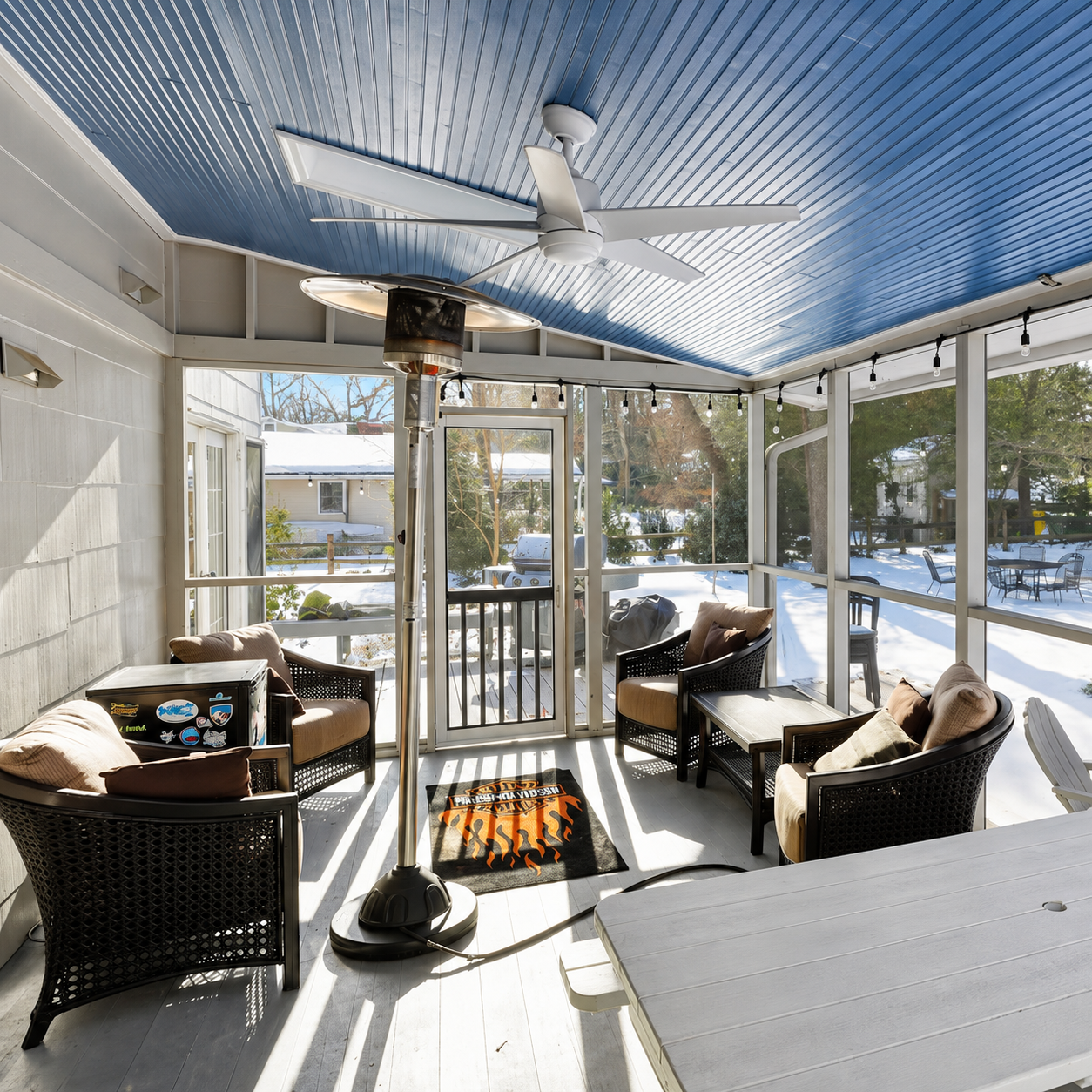 Screened porch at Bayberry Retreat with comfortable seating and views of the outdoor property.