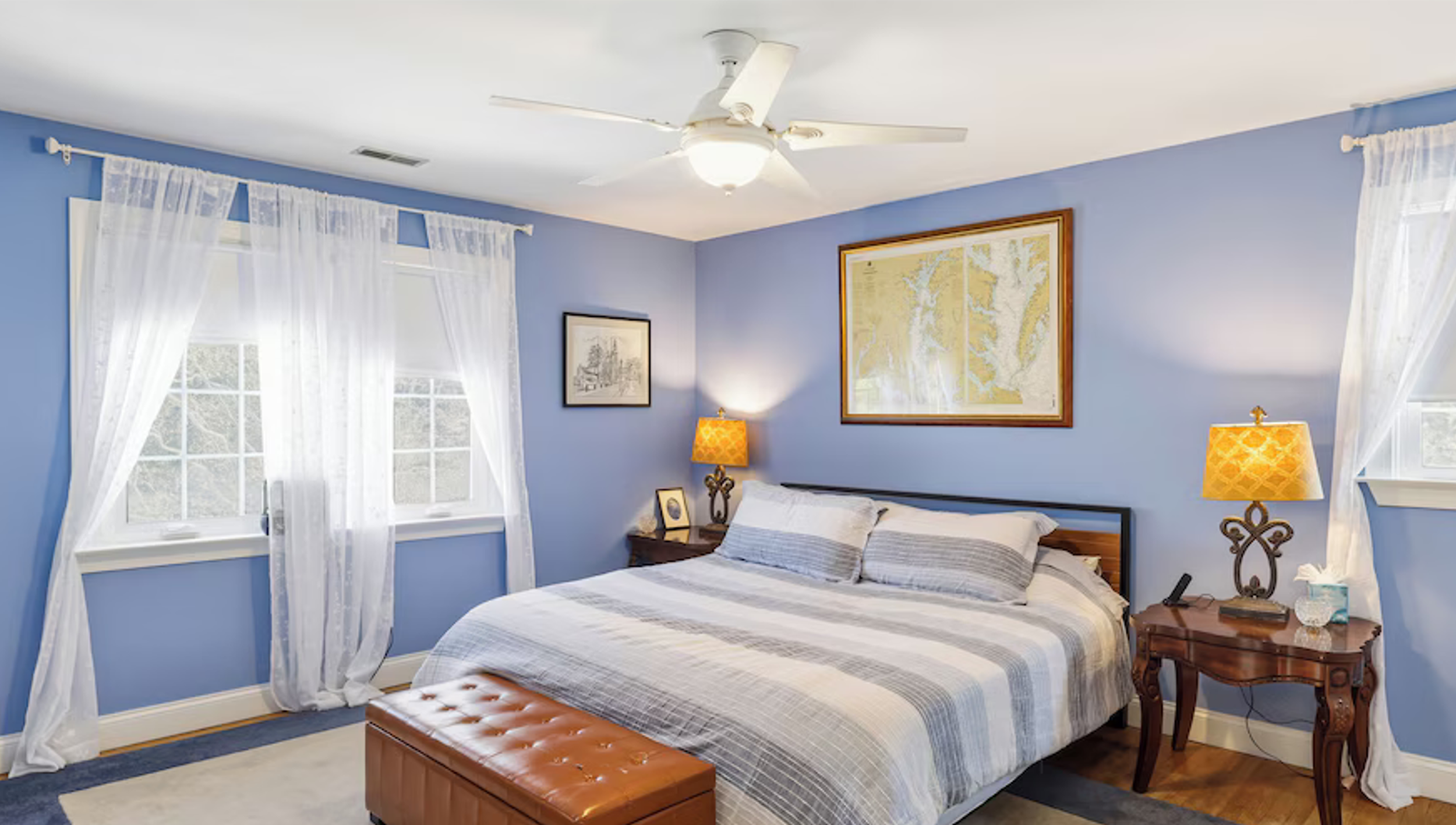 Comfortable blue bedroom with bedside tables and natural light at Bayberry Retreat near Annapolis.