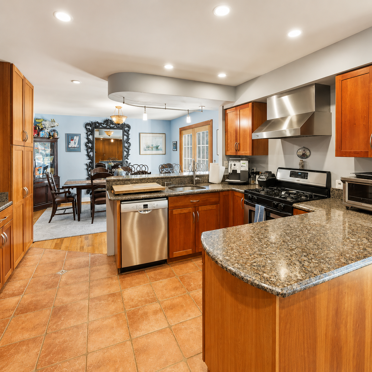 Fully equipped kitchen with gas range, stainless steel appliances, and dining area at Bayberry Retreat in Arnold, Maryland.
