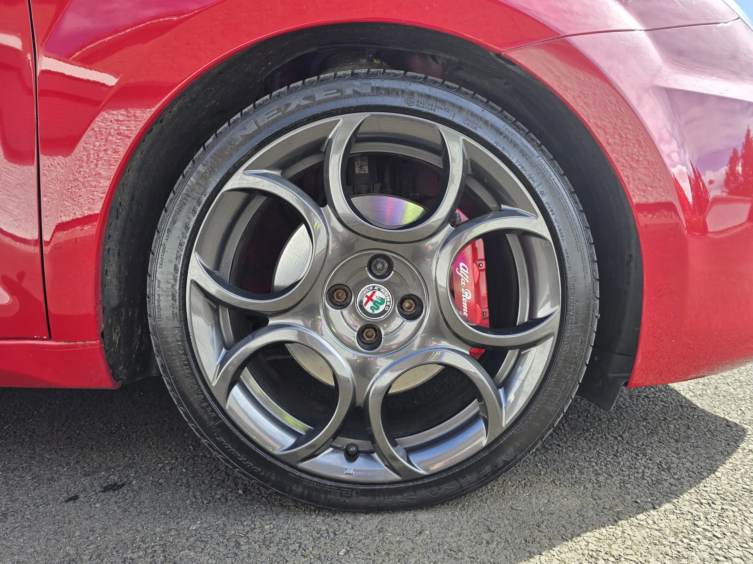 Alfa Romeo Mito 18 inch teledial-style alloy wheels and 305mm Brembo 4-piston brake calipers.