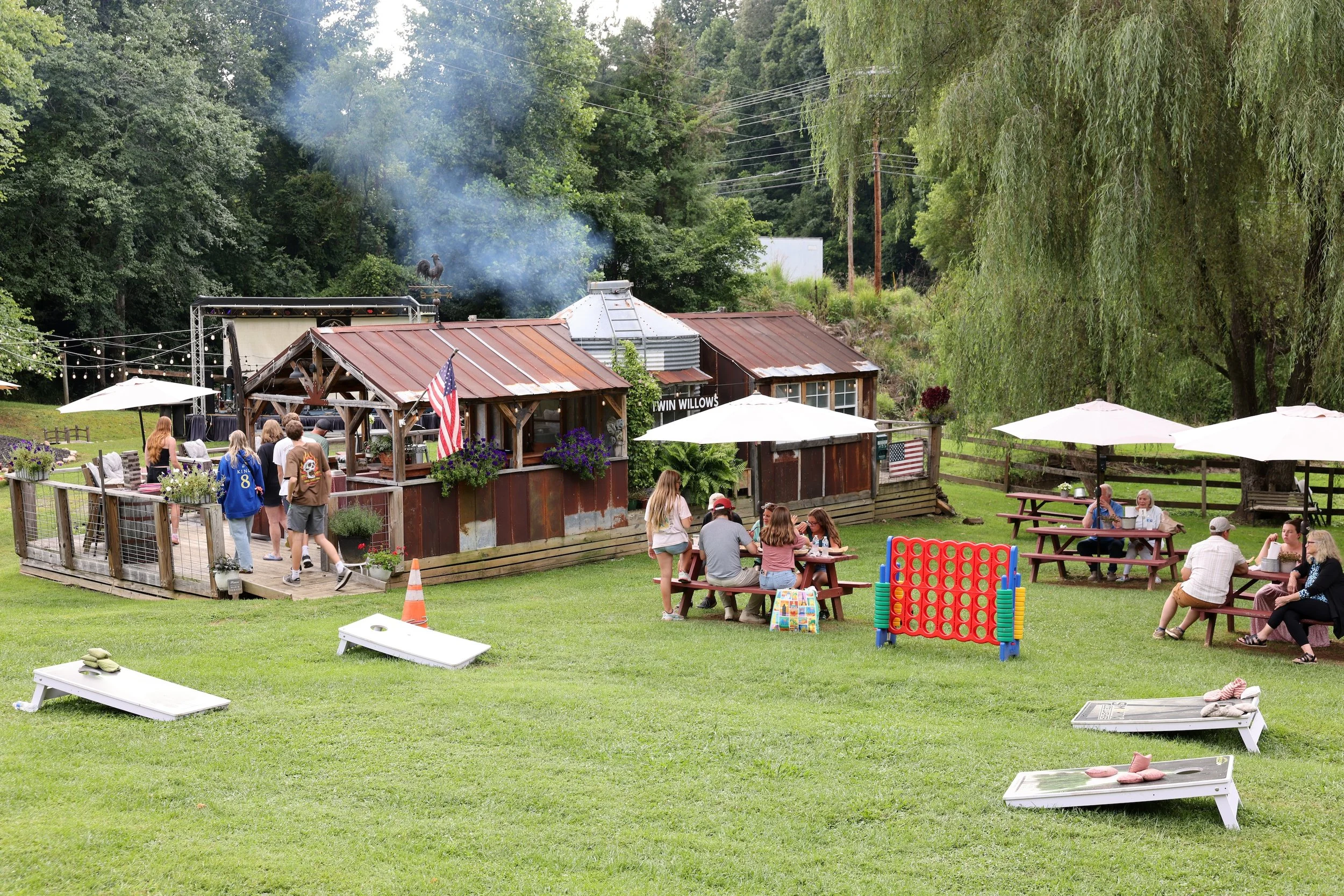 Guests enjoying lawn games and outdoor seating at Twin Willows in Mars Hill.