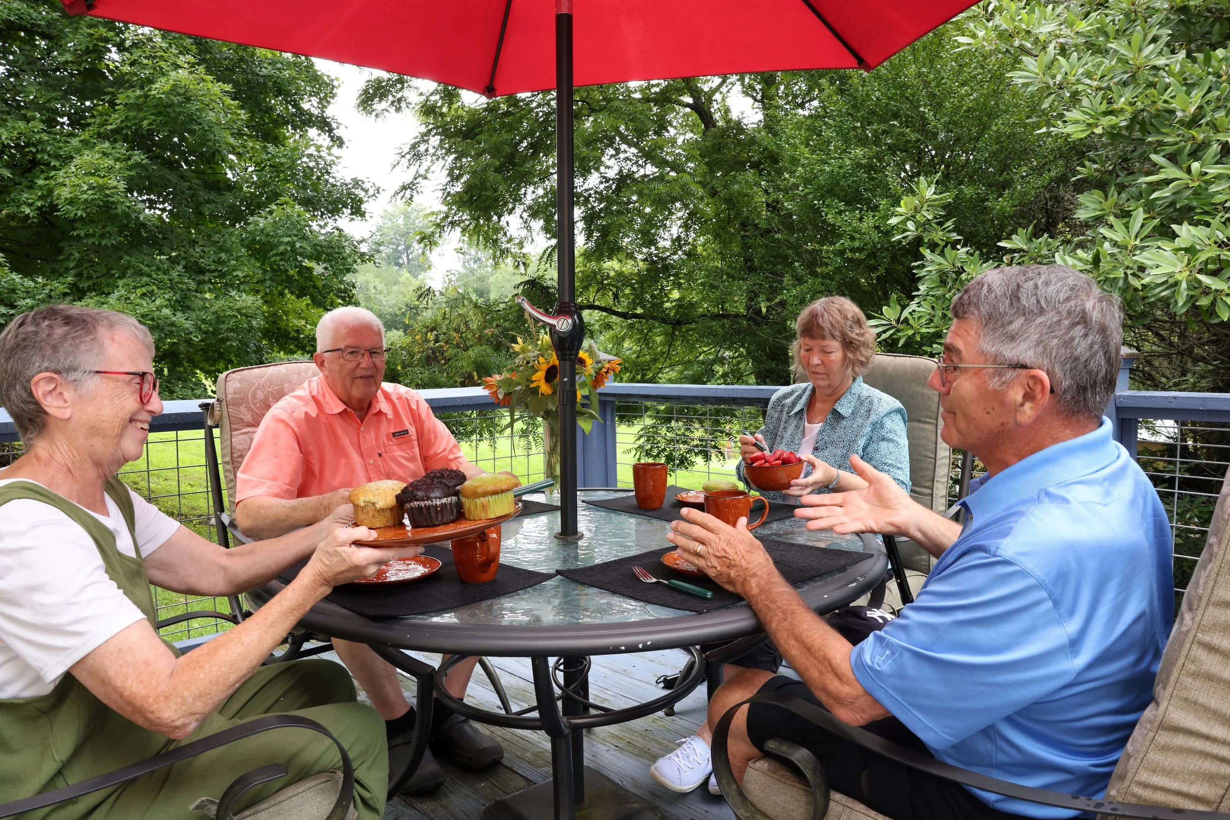 Guests sharing food and conversation outdoors at Twin Willows.