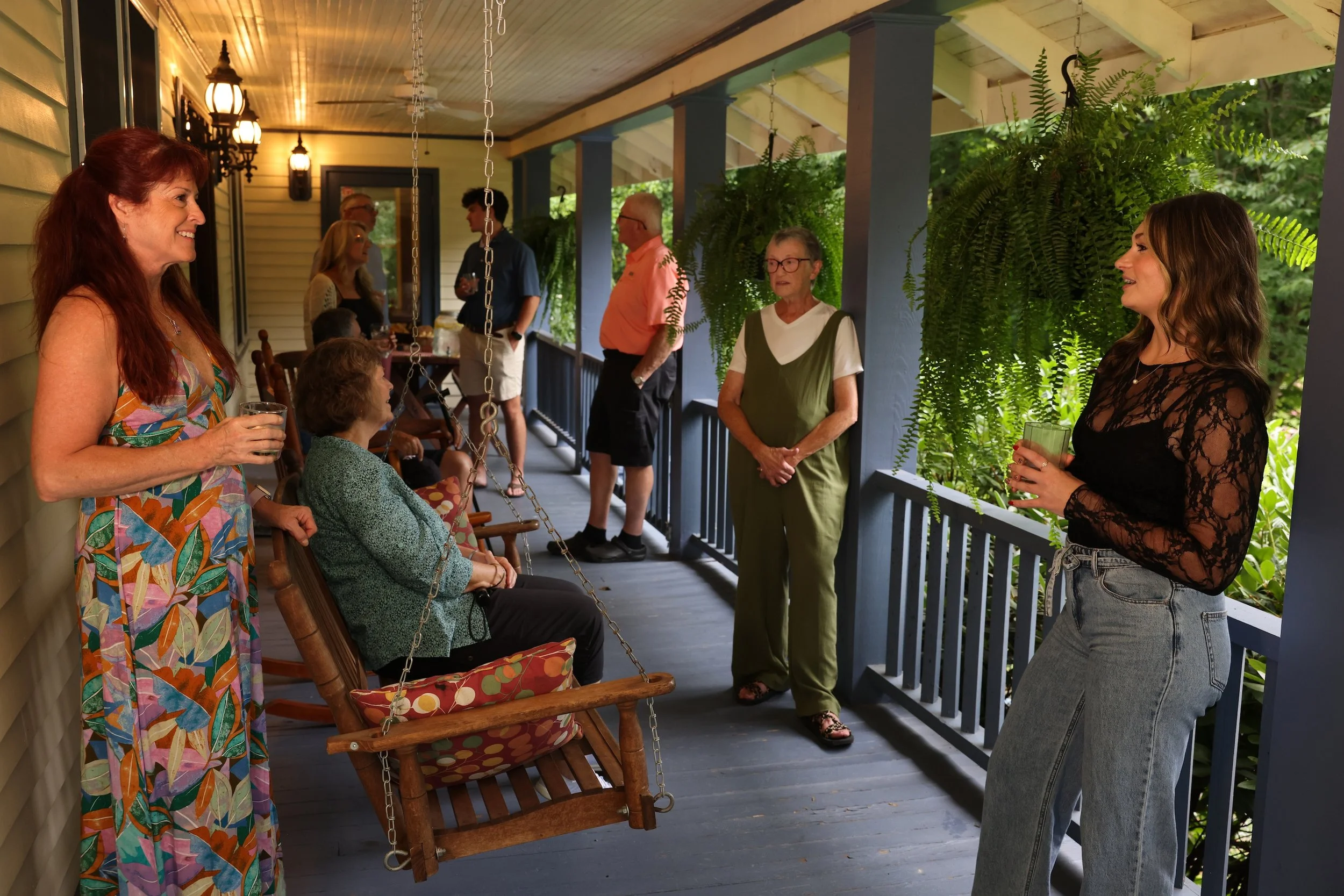 Family and friends gathering on the porch at Stines House at Twin Willows.