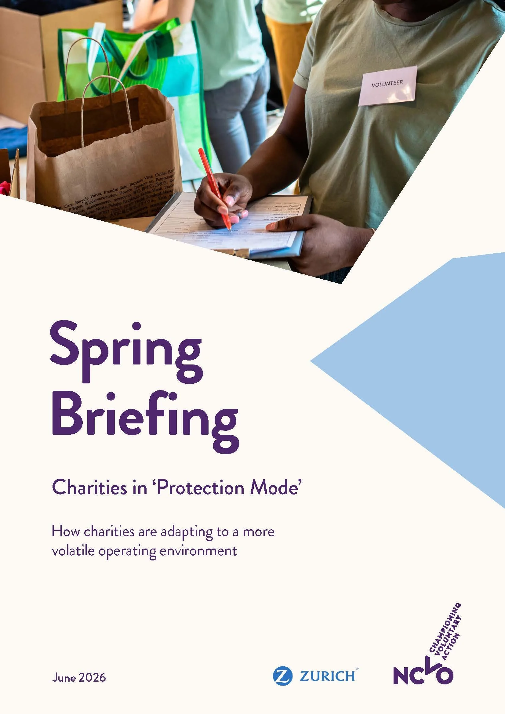 Cover of "Spring Briefing: Charities in 'Protection Mode'" by NCVO in partnership with Zurich, dated June 2026, showing a volunteer with a name badge writing on a clipboard beside donated bags and boxes.