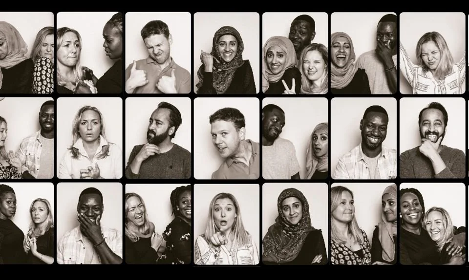 Close-up grid of black-and-white photo-booth style portraits showing a diverse group of people mid-laugh, gesturing, and pulling playful expressions together.