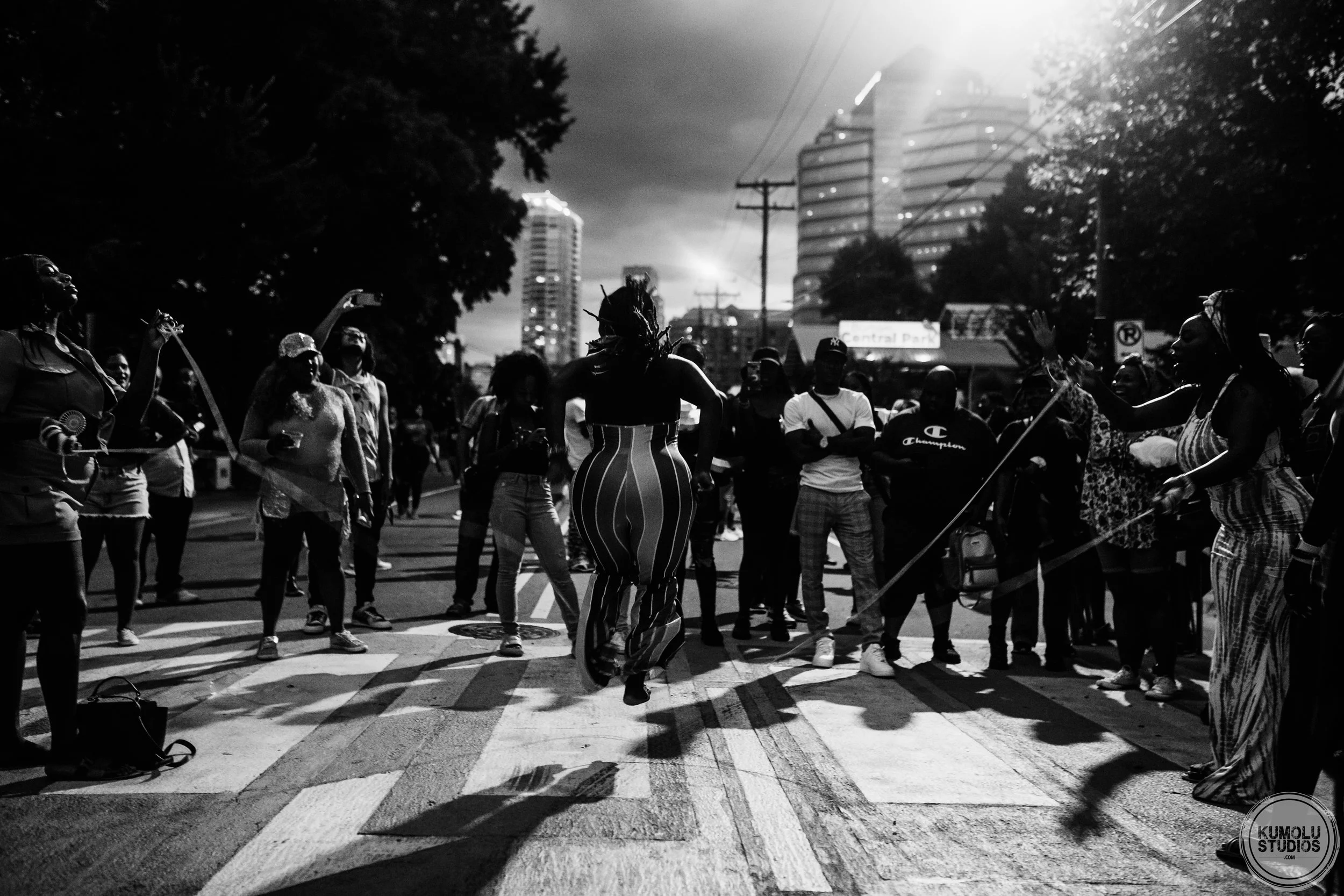 Group of people dancing and socializing outdoors at night at the Black August in the Park event in Durham, North Carolina, photographed by Durham and Raleigh-based photographer, Dare Kumolu-Johnson.