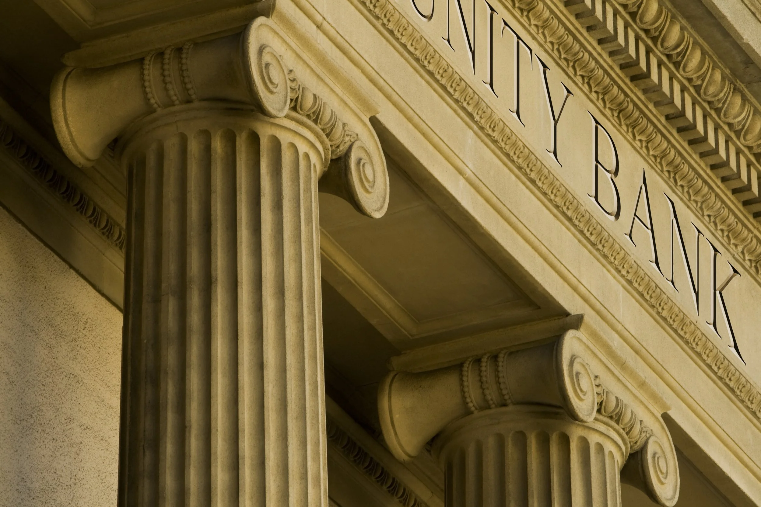 Classical architecture with ornate columns and "BANK" sign