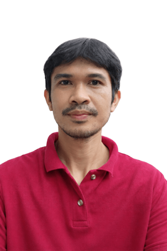A man with dark hair and a slight smile, wearing a red polo shirt, against a plain background.