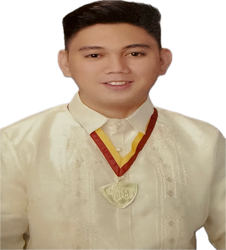 Young man wearing a traditional cream-colored shirt with red and yellow accents, smiling at the camera.