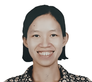 A smiling person with short black hair, wearing a patterned shirt, against a plain background.