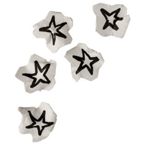 Five white star-shaped candies with black star designs on top, placed above a yellow background.