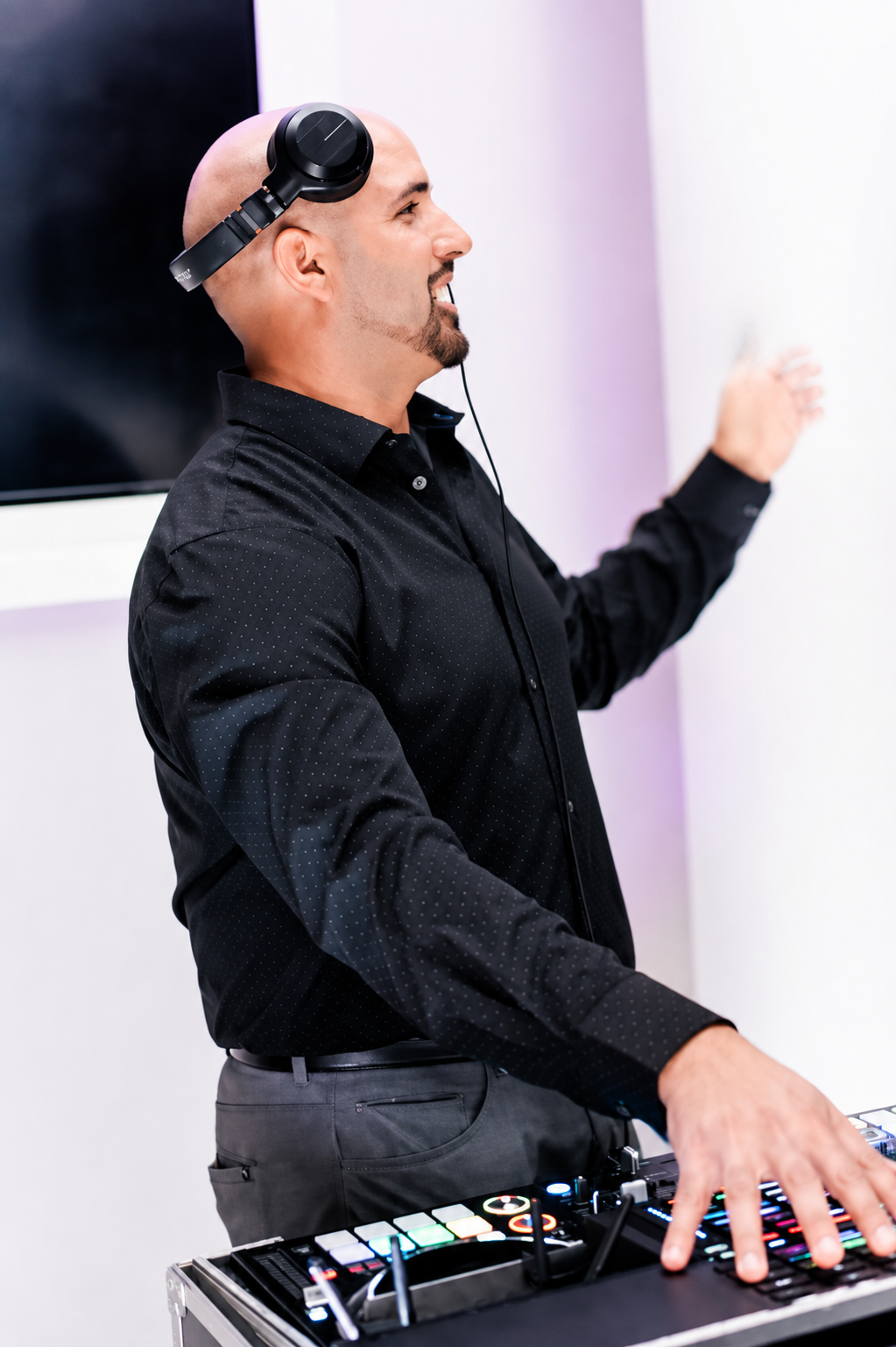 Evented Sound DJ performing with headphones at a professional event.