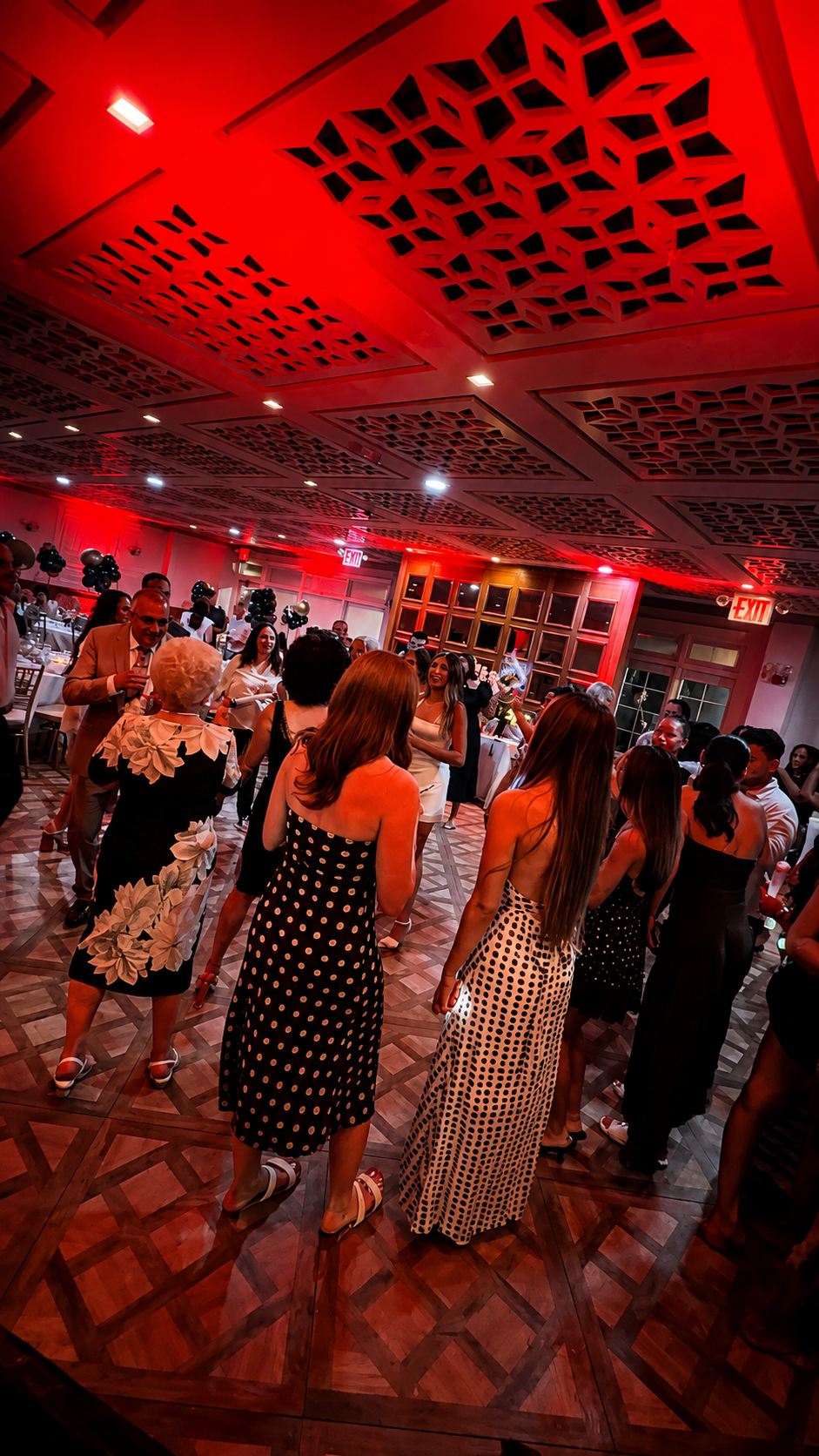 Guests dancing under red event lighting