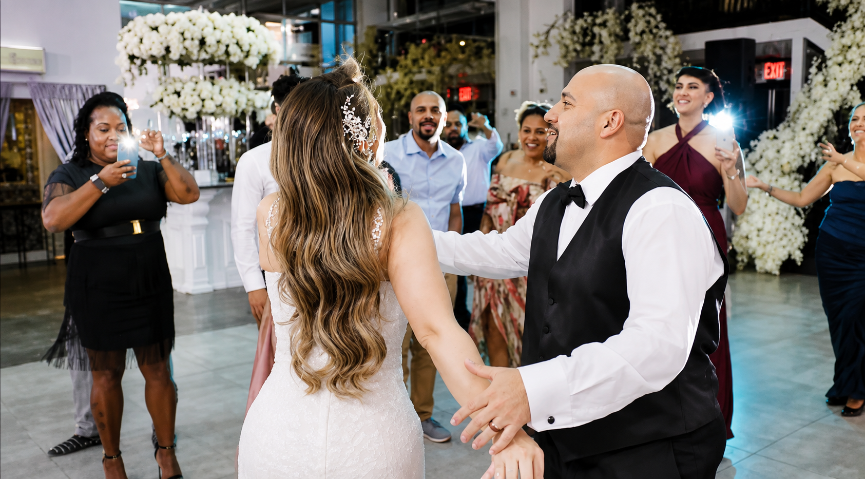Bride and groom dancing with guests at an Evented Sound wedding reception.
