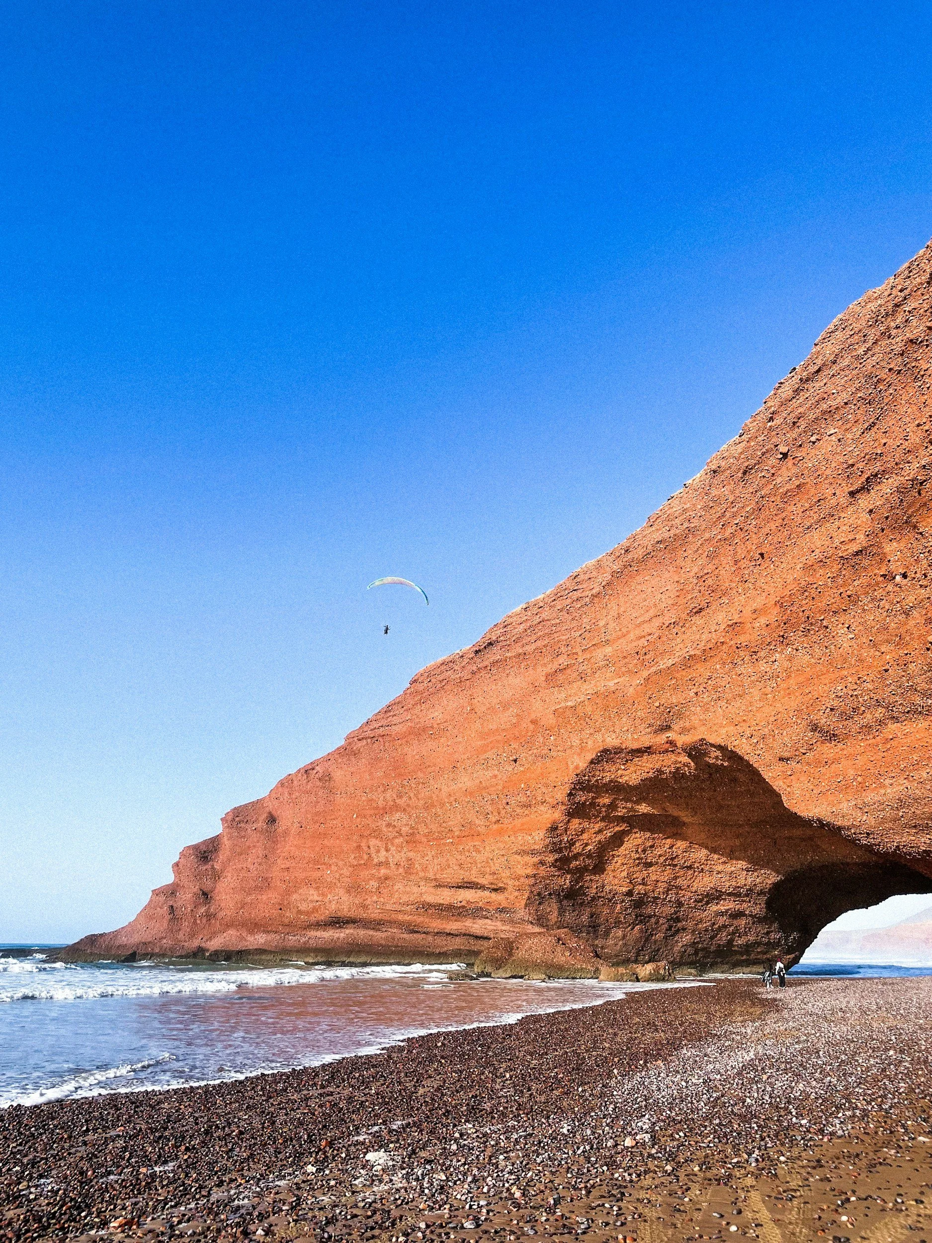 Picture of a big red rock on the beach called Legzira.