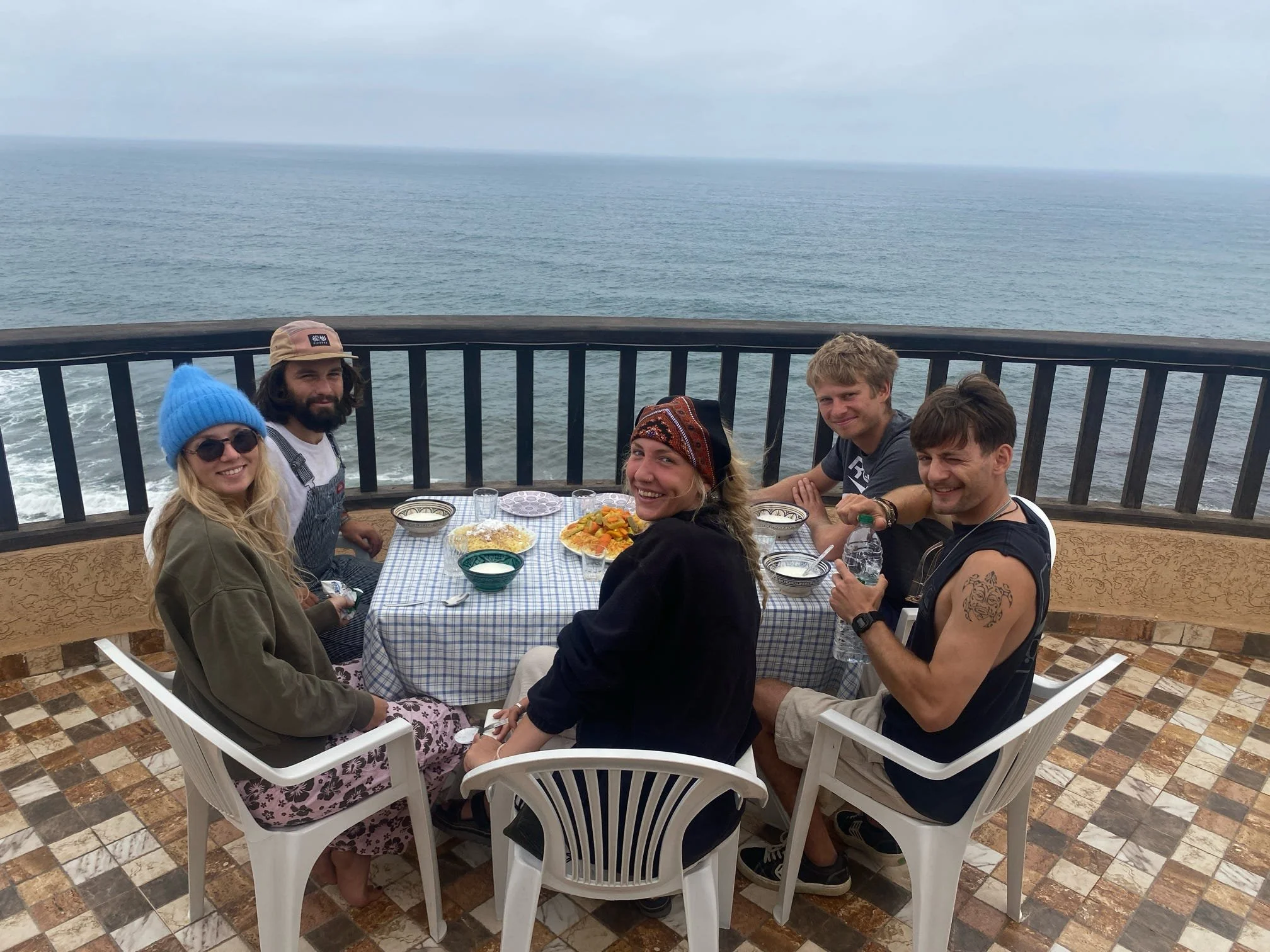 Guests enjoying a shared Moroccan meal at TAZURF in Mirleft
