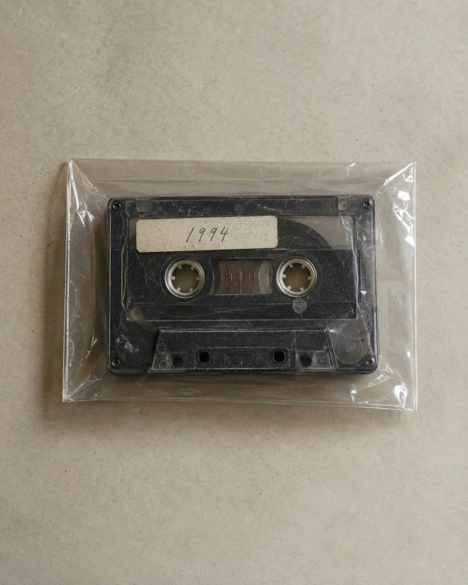 An old cassette labeled 1994 in an archival sleeve.