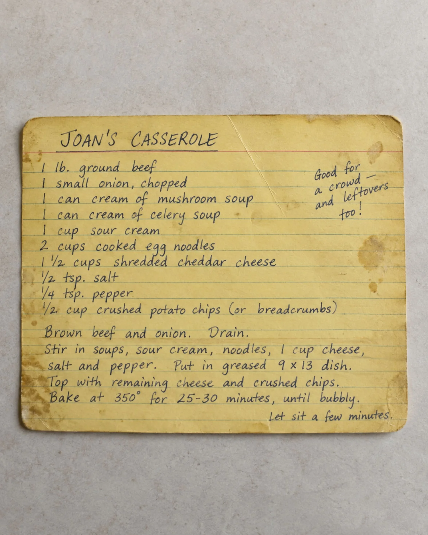 A worn yellow recipe card titled Joan's Casserole.