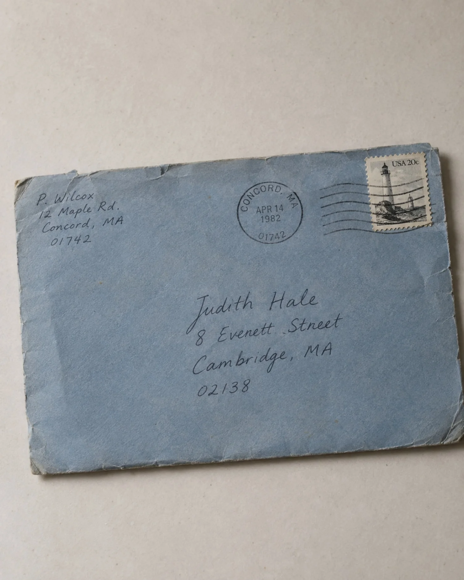 A worn blue envelope from 1982 addressed to Judith Hale.