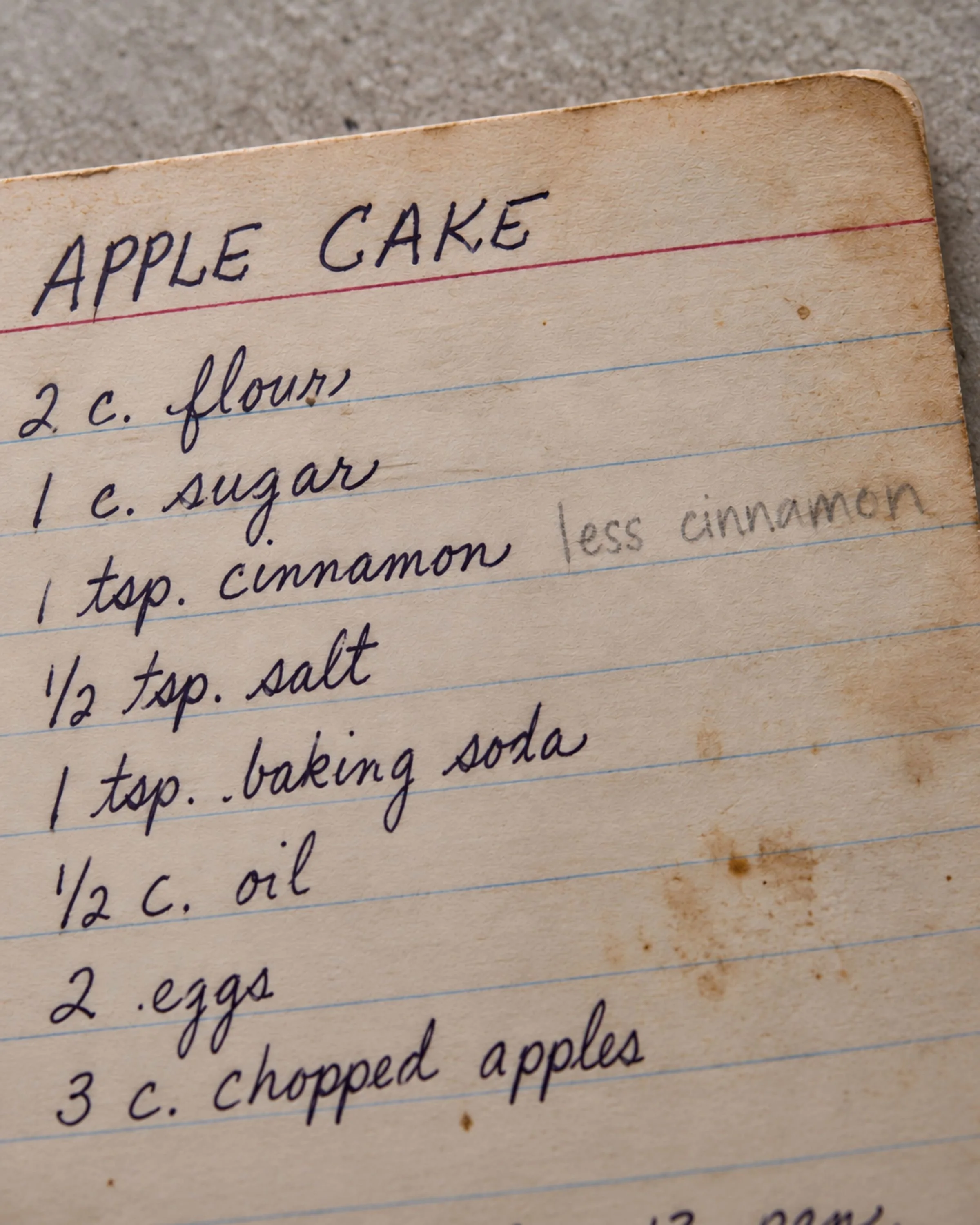 Close detail of Claire's pencil note on the Apple Cake recipe.