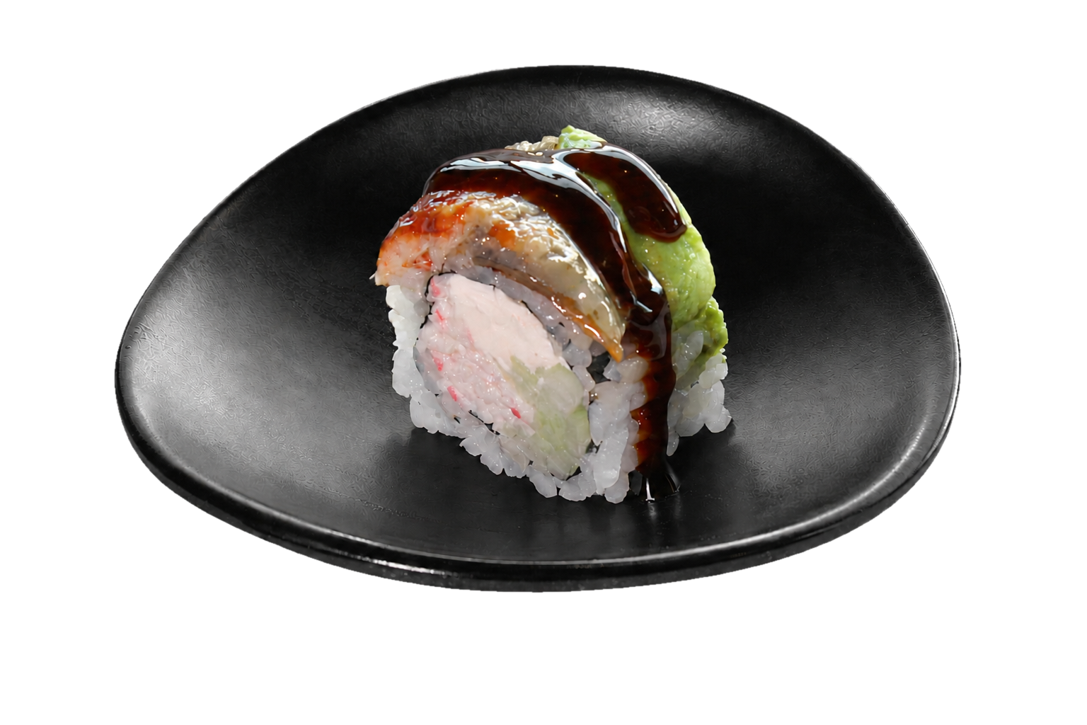 A piece of sushi roll with rice, crab, cucumber, topped with avocado, eel sauce, and wasabi, served on a black plate.