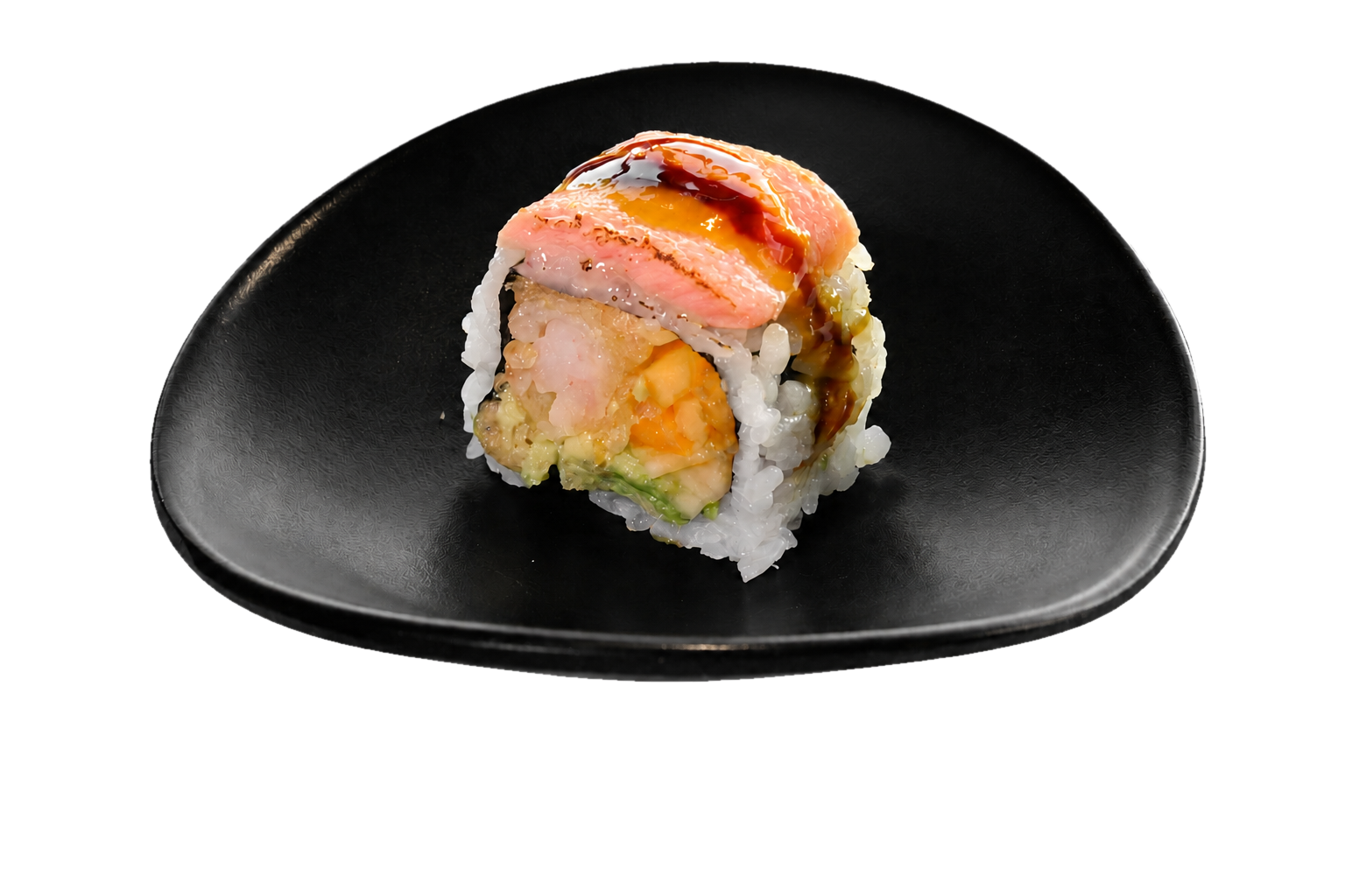 A piece of sushi with various seafood and vegetables topped with a drizzle of sauce, served on a black plate