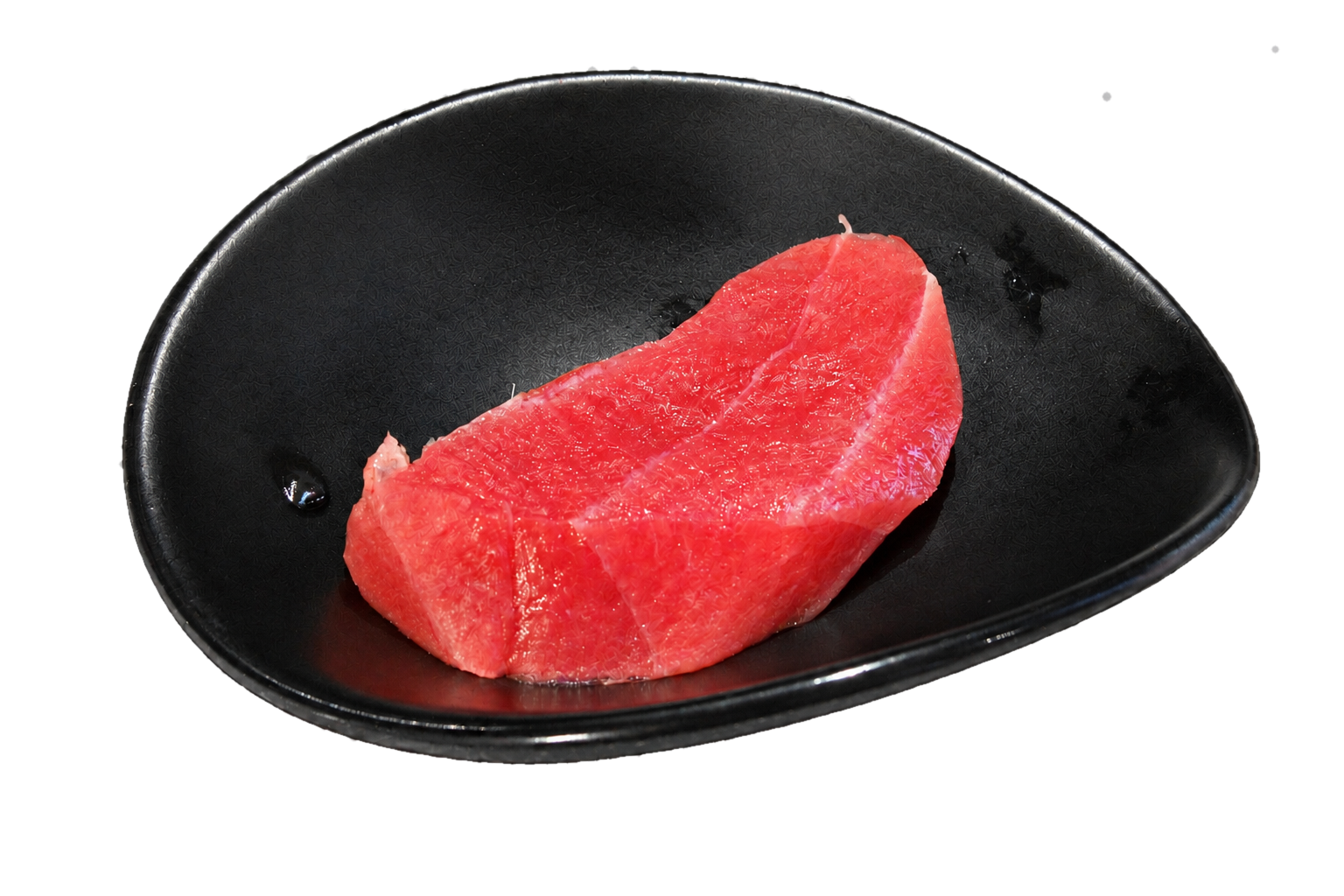 A slice of fresh, raw tuna fish on a black plate