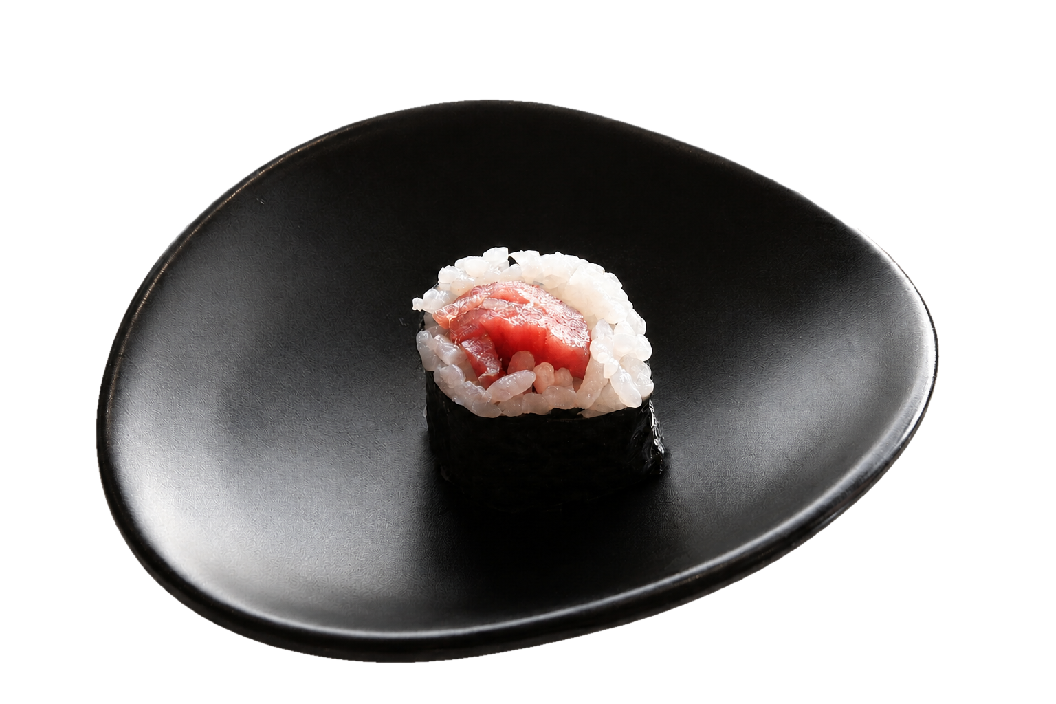 A piece of sushi with raw fish and rice, wrapped partly in seaweed, placed on a black plate.