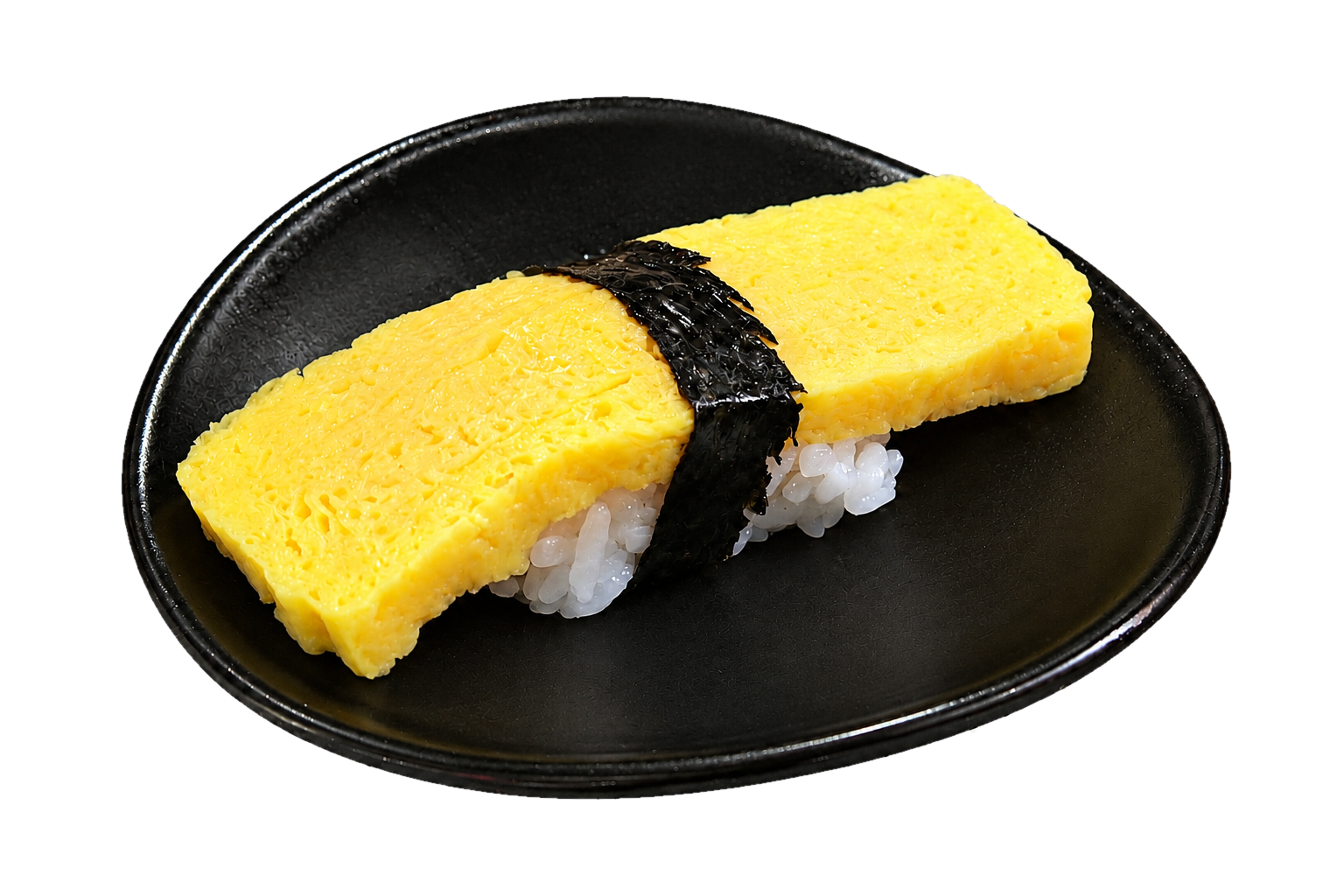 A piece of Japanese sushi with a yellow egg omelette on rice, secured with a strip of black seaweed, served on a black plate.