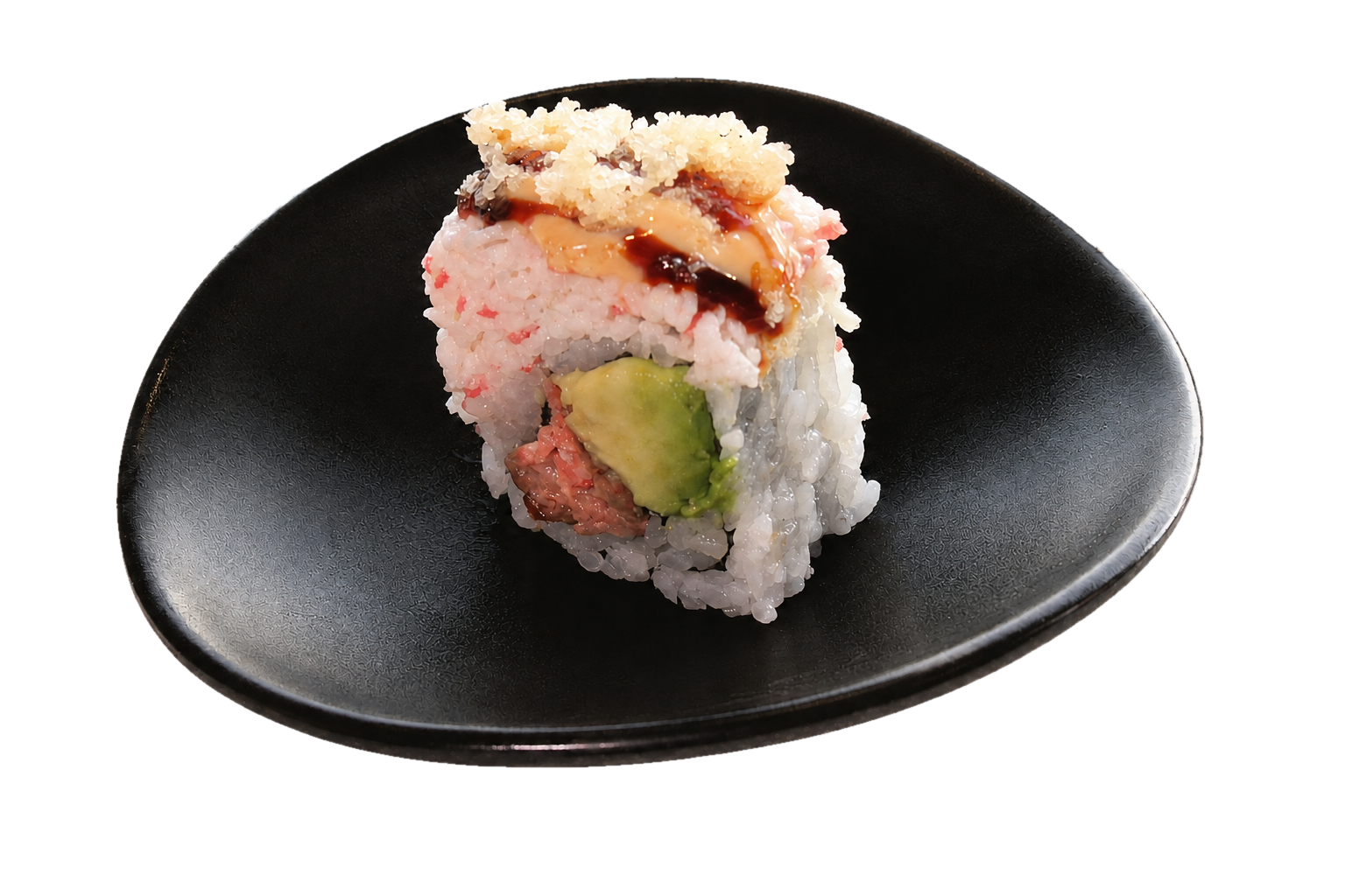 Close-up of a sushi roll on a black plate with various ingredients visible, including avocado, fish, rice, and toppings like tempura flakes and sauce.